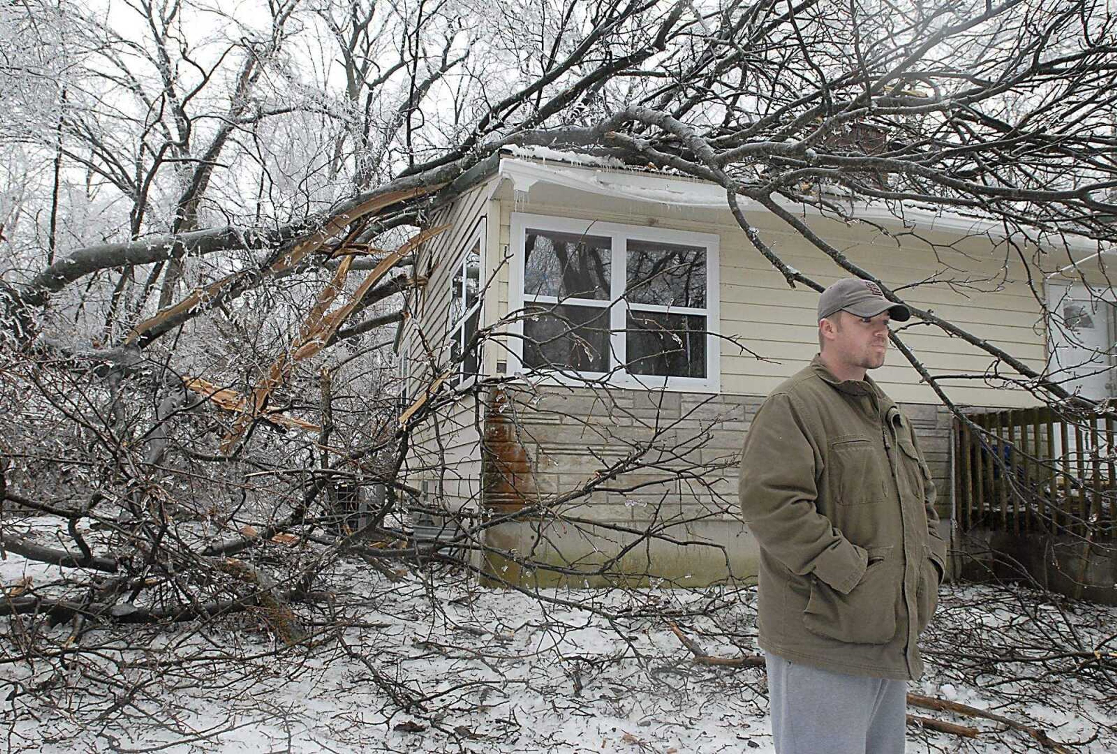 KIT DOYLE ~ kdoyle@semissourian.com
Willie Tatum scanned the damage to his yard as a tree rested on his house last night on Carter St. in north Cape Girardeau. He and his family woke when the tree came through the wall into his daughter's closet Monday night.