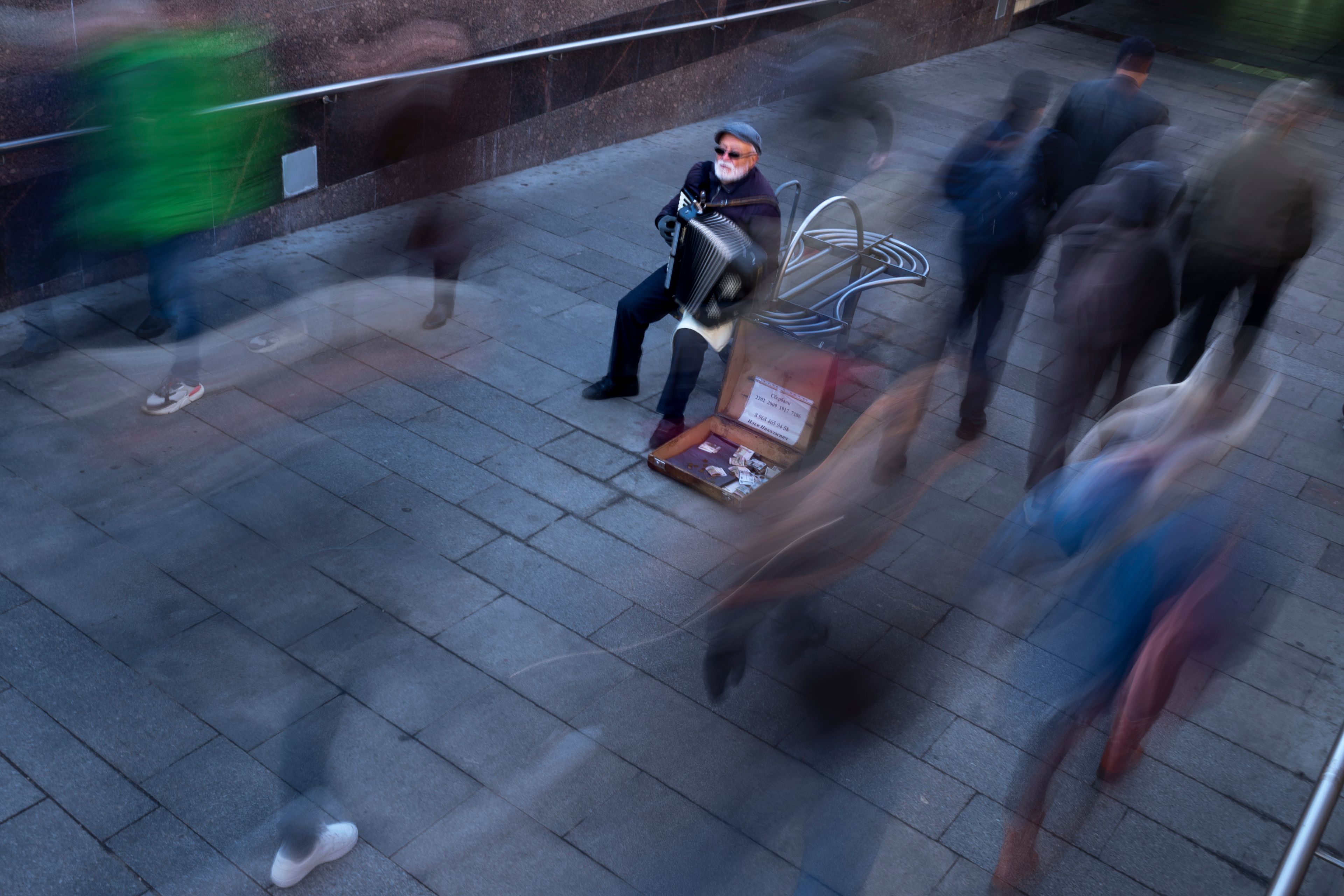 An elderly man plays the accordion in the morning in the hope of getting some small money at the entrance to the subway in Moscow, Russia, Thursday, Oct. 17, 2024. (AP Photo/Alexander Zemlianichenko)