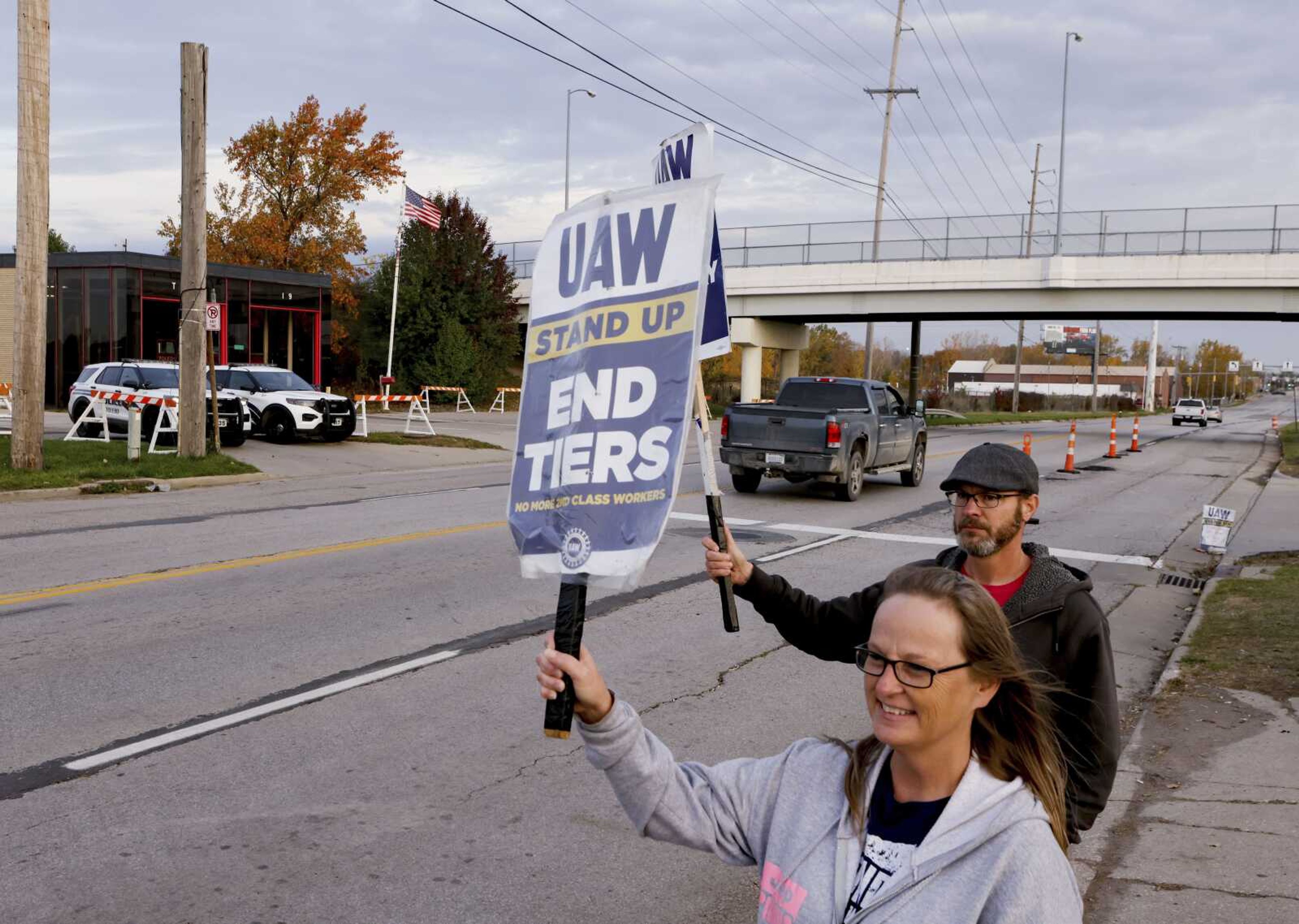 Two members of United Auto Workers Local 12 employed at Stellantis' Toledo, Ohio, assembly plant picket Thursday, Oct. 26. UAW has announced a tentative agreement with both Stellantis and Ford Motor Company to end a strike that began in mid-September at both automakers. A job action at General Motors continues at presstime.