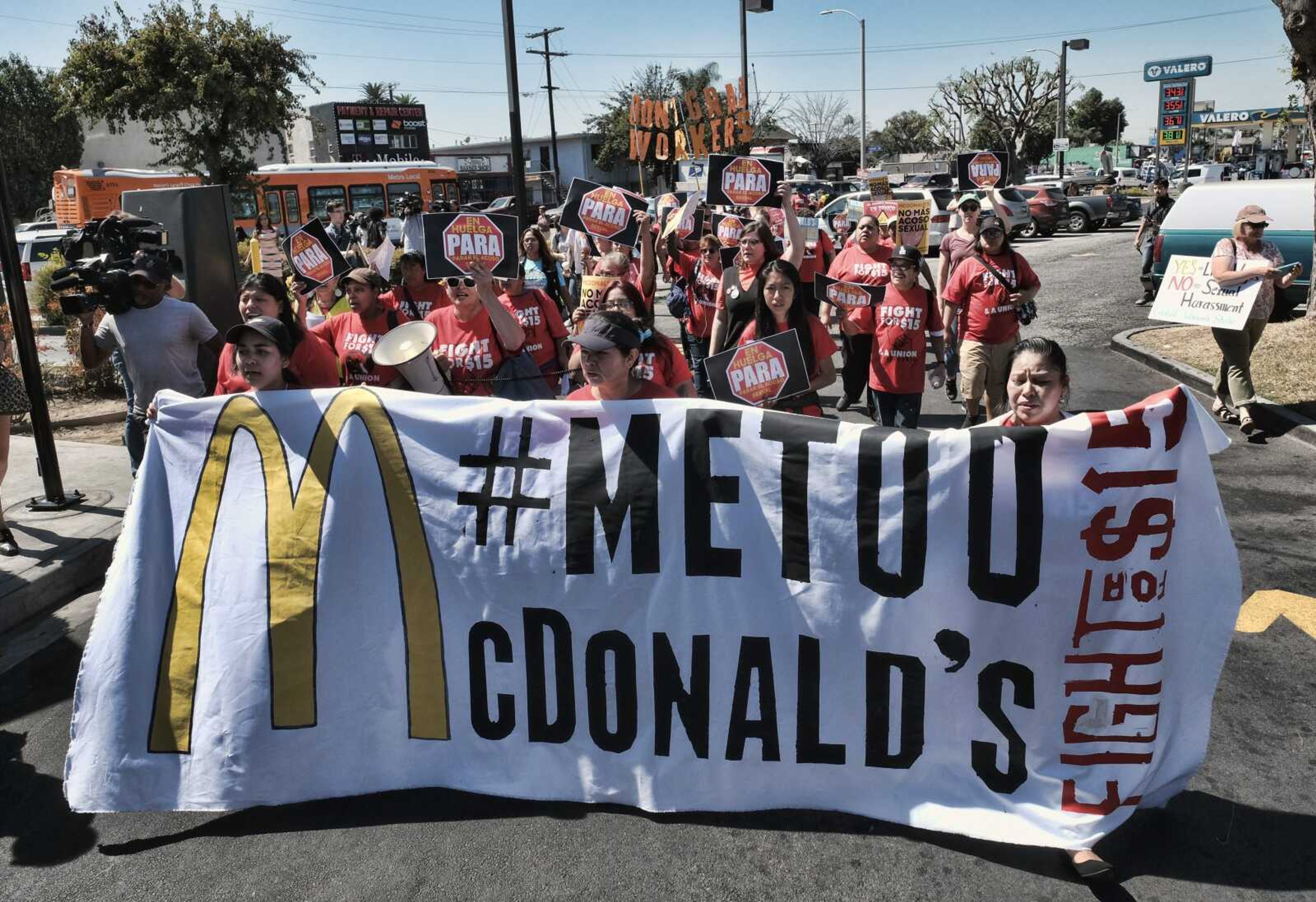 McDonald's workers carry a banner and march toward a McDonald's in south Los Angeles in 2018. Roughly a third of American workers say they've changed how they act at work in the past year, as the #MeToo movement has focused the nation's attention on sexual misconduct.