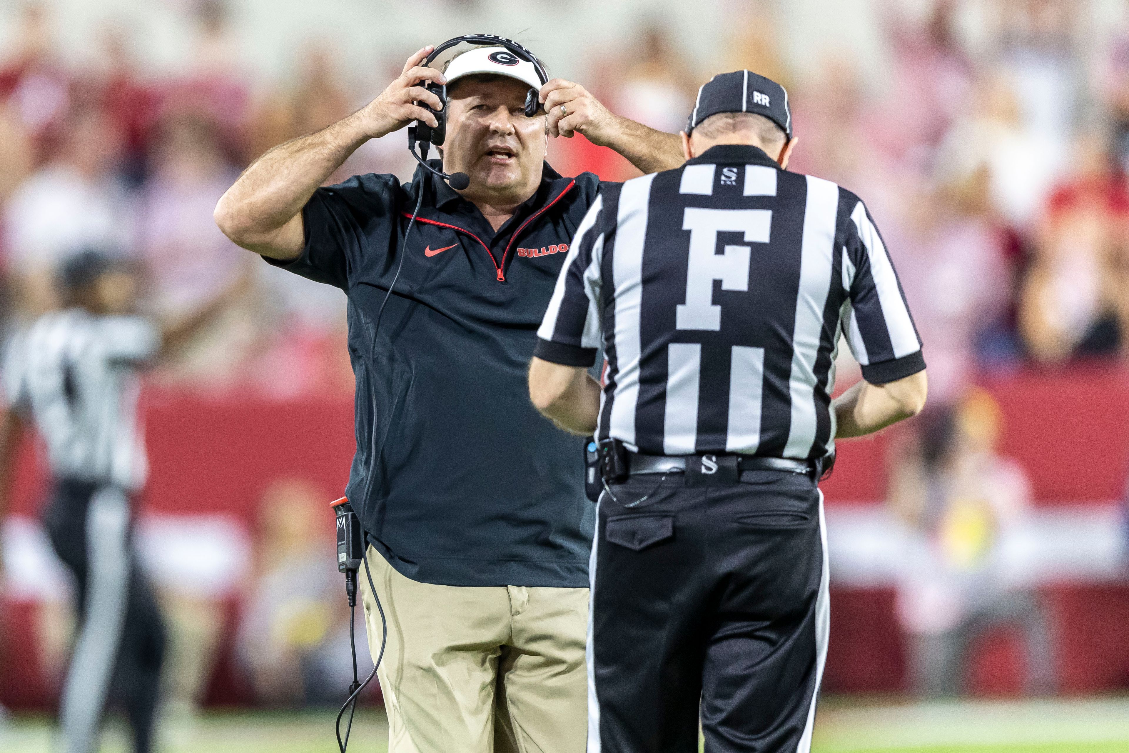 Georgia head coach Kirby Smart runs to a referee to discuss a call during the first half of an NCAA college football game against Alabama, Saturday, Sept. 28, 2024, in Tuscaloosa, Ala. (AP Photo/Vasha Hunt)