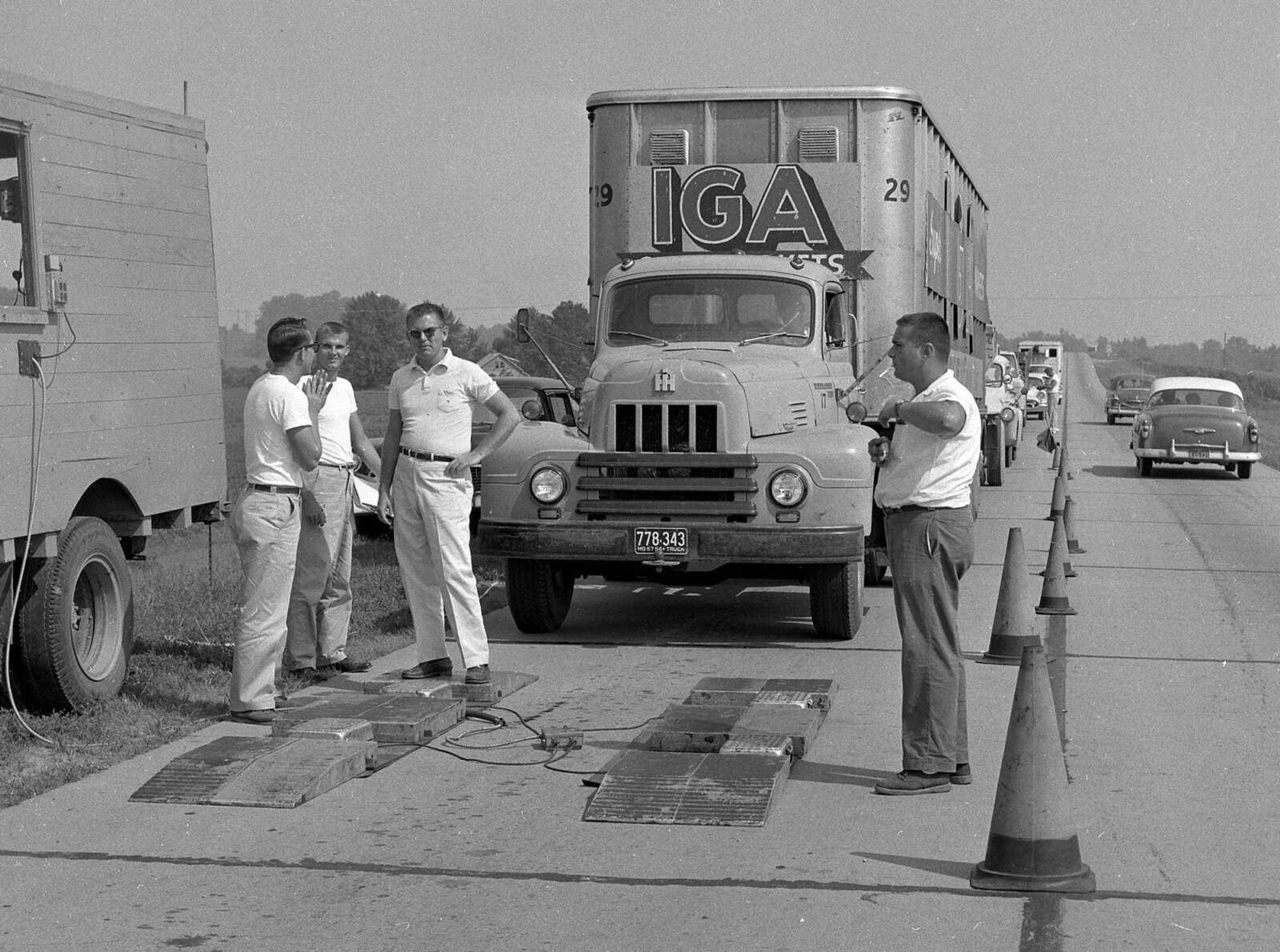 An IGA truck, with a 1957 license plate, is ready to drive onto a portable scale. If you can provide information about this image, contact librarian Sharon Sanders at ssanders@semissourian.com.