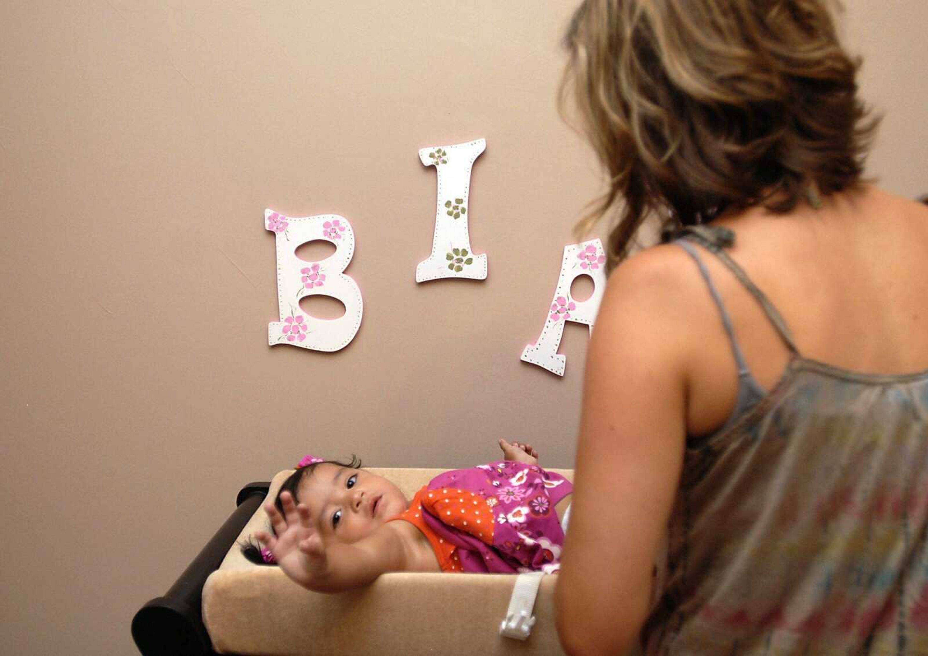 KIT DOYLE ~ kdoyle@semissourian.com
Chantelle Becking checked her daughter Bianca's diaper Thursday morning, August 21, 2008, at their Cape Girardeau home. The Beckings adopted Bianca in Guatemala almost a year ago.