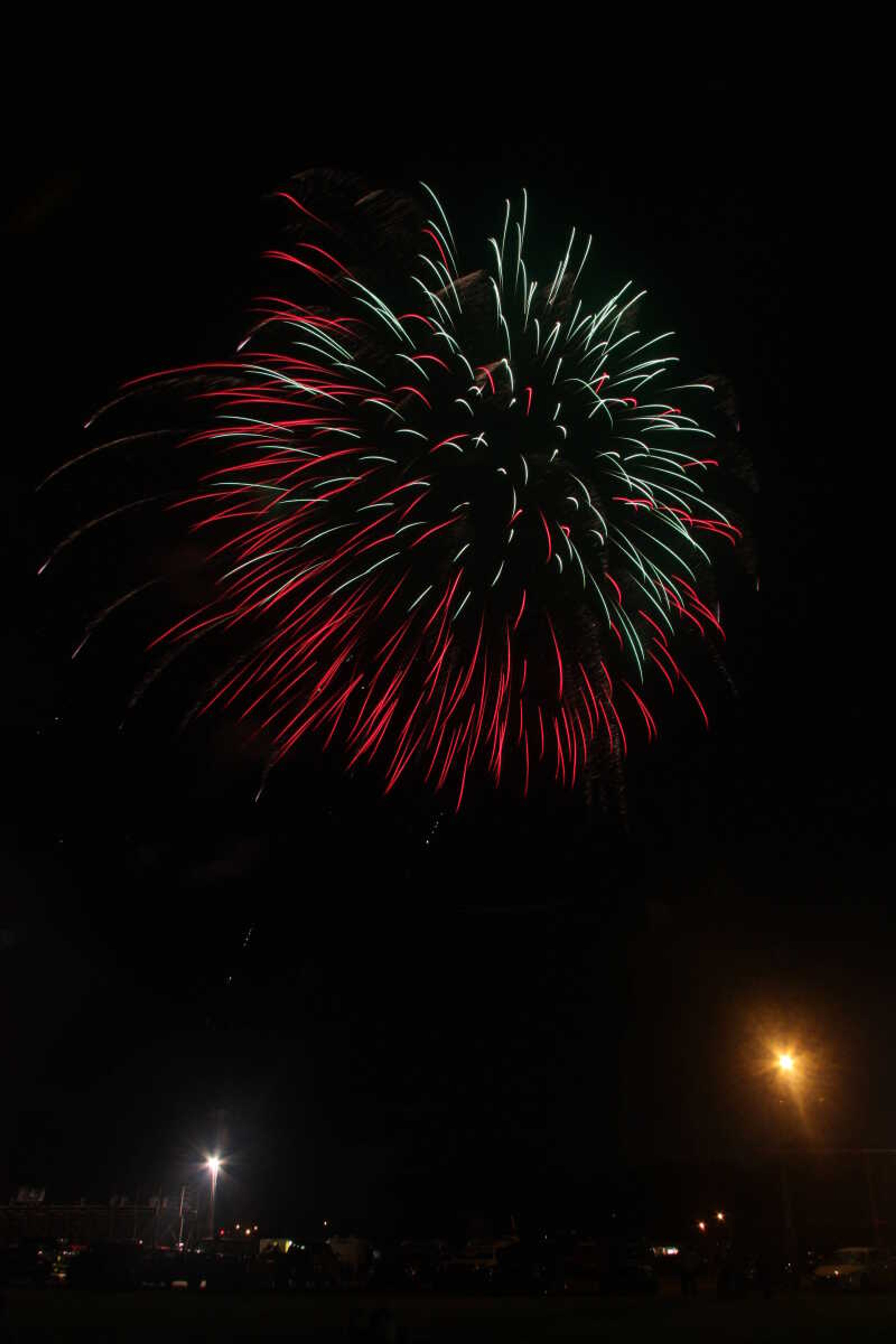 Picture of the fireworks display in Cape Girardeau's Arena Park, taken from a field south of the park.