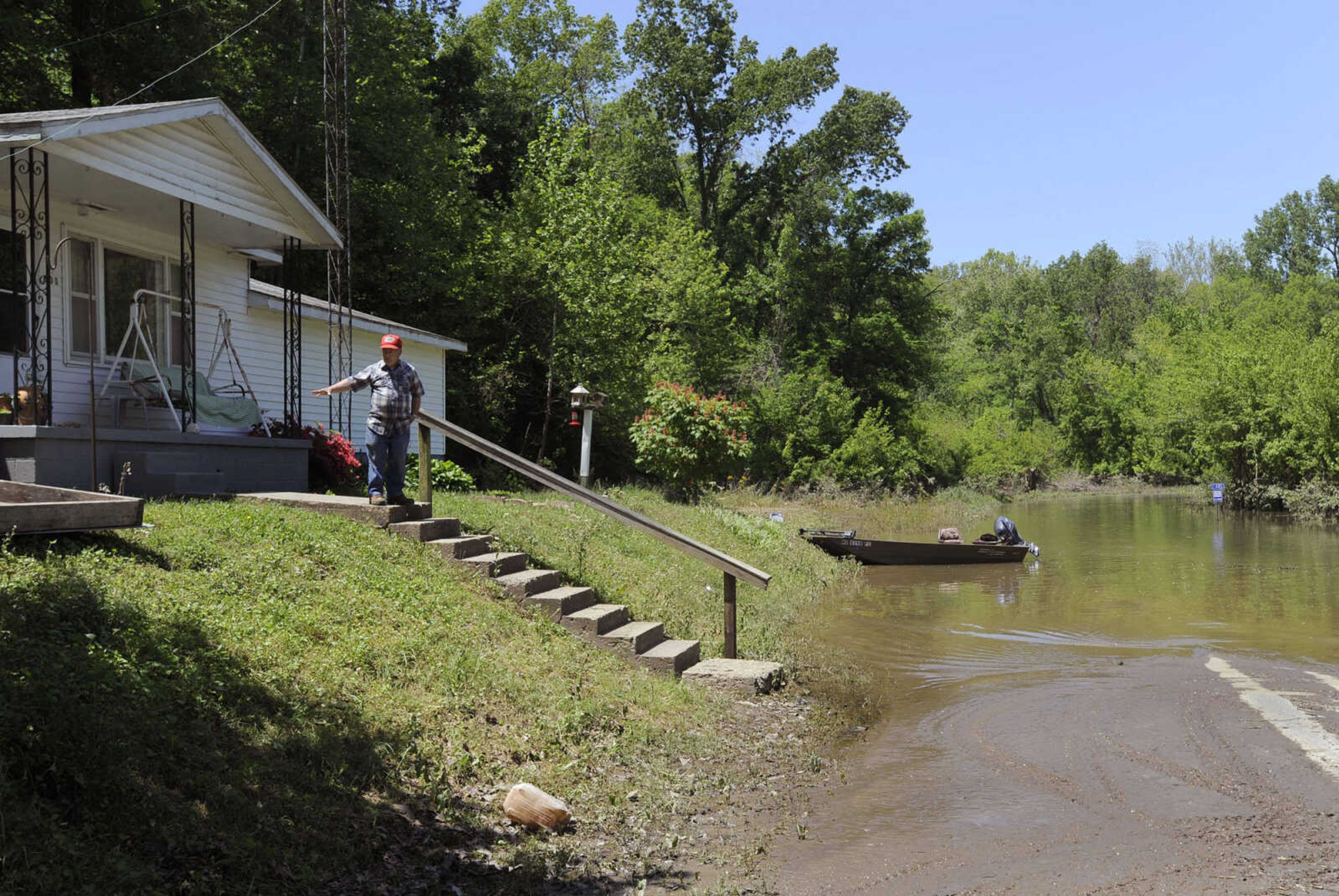 FRED LYNCH ~ flynch@semissourian.com
Harold Kraft stands on the step in front of his house Sunday, May 8, 2011 in Commerce, Mo. that he says floodwaters reached when the Mississippi River was at its highest point last week. Water remains over Water street, County Road 321, to the north of his house.