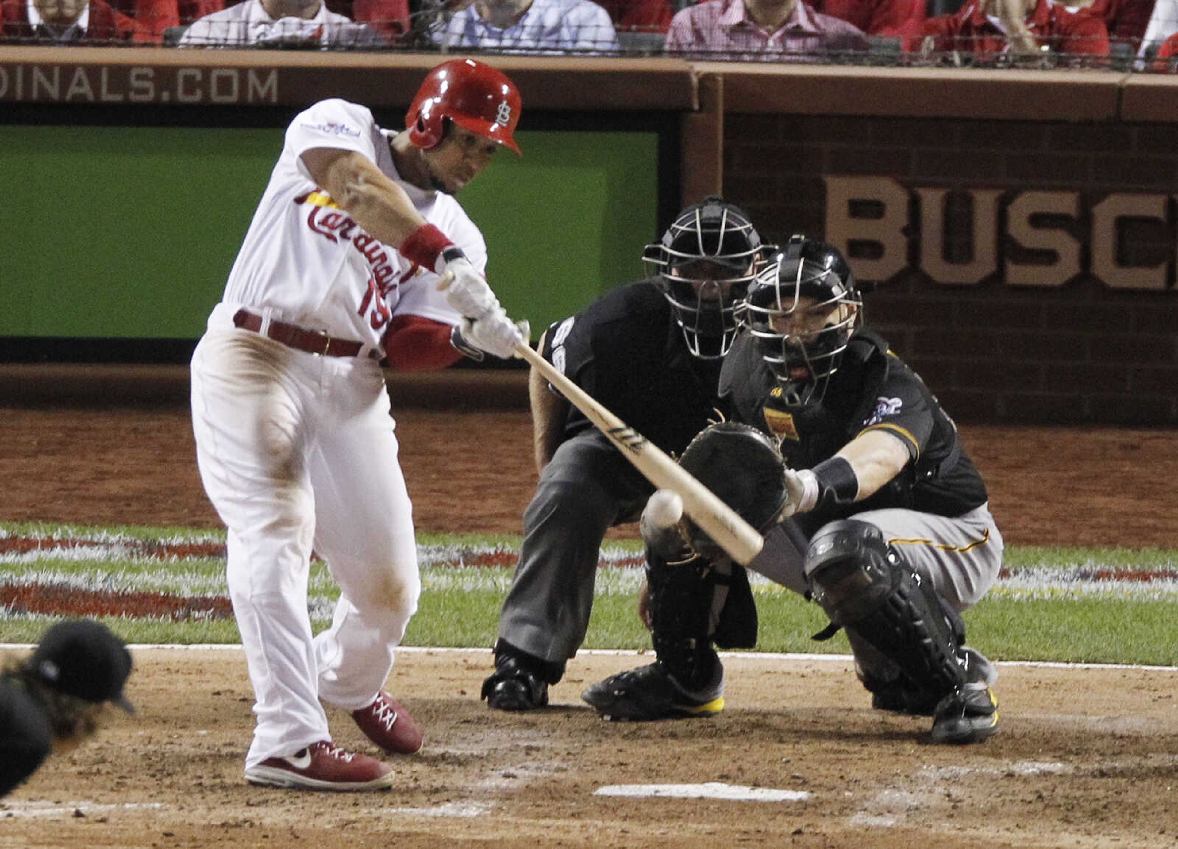 St. Louis Cardinals' Jon Jay drives in Matt Holliday with a single in the sixth inning against the Pittsburgh Pirates in Game 5 of a National League baseball division series on Wednesday, Oct. 9, 2013, in St. Louis. Catching for the Pirates is Russell Martin. (AP Photo/Sarah Conard)