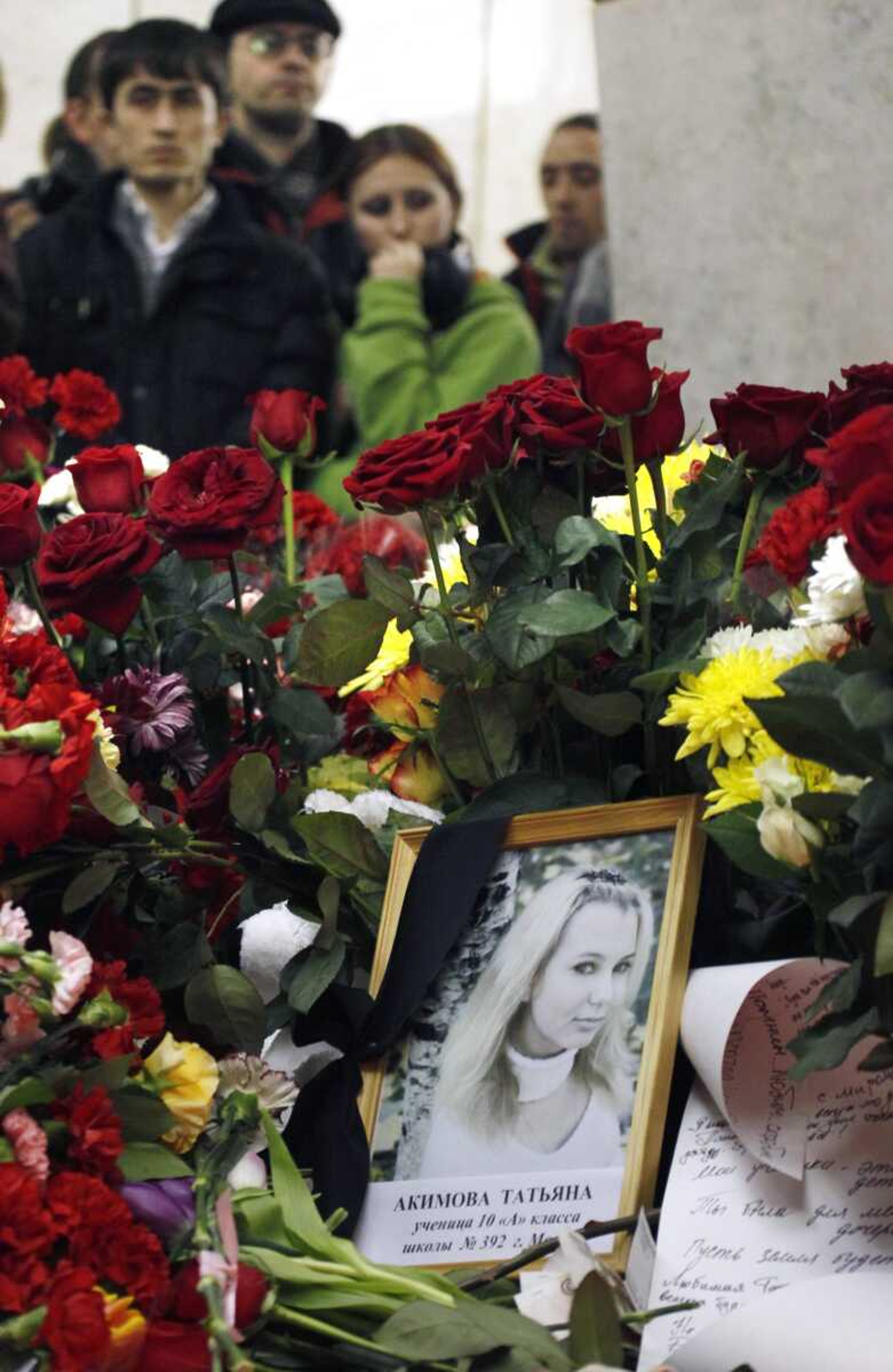 A portrait of high school student Tatyana Akimova, killed in a subway blast, is placed Tuesday at the sight of an explosion at Lubyanka subway station in Moscow. Flowers overflowed Tuesday in two Moscow subway stations in memory of the 39 passengers killed. (Dmitry Lovetsky ~ Associated Press)