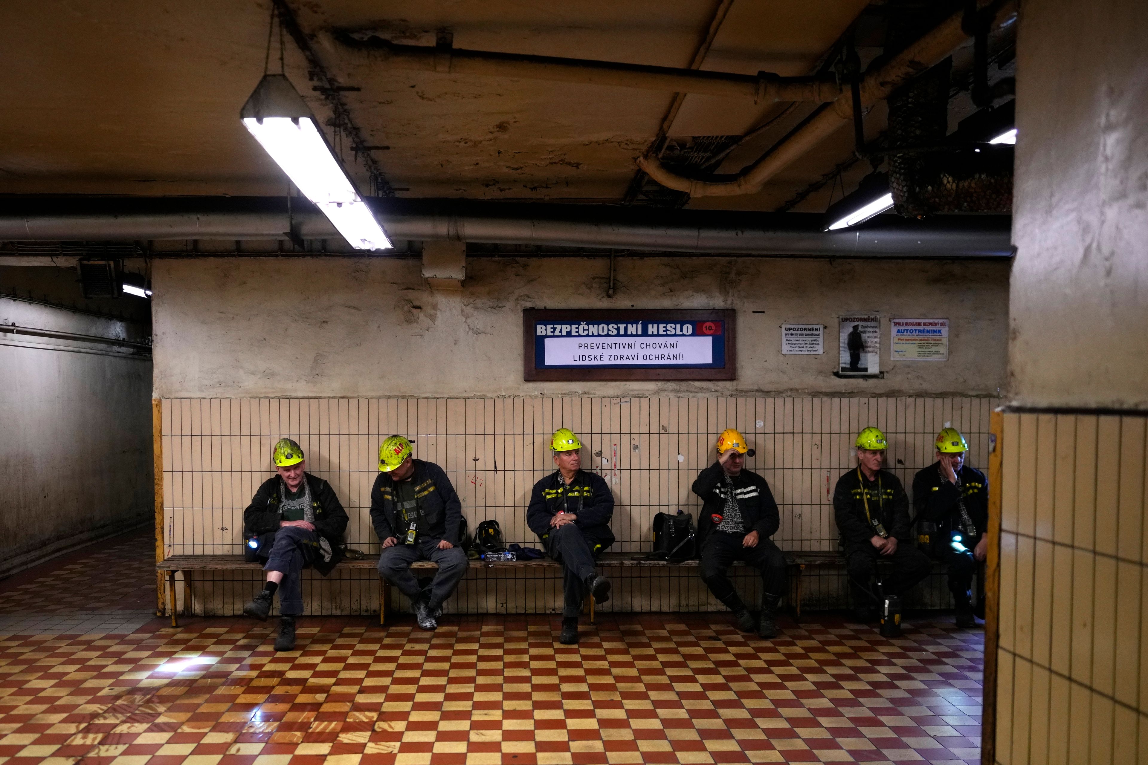 Miners sit on a bench before going down to the CSM coal mine in Stonava, Czech Republic, Monday, Oct. 14, 2024. (AP Photo/Petr David Josek)