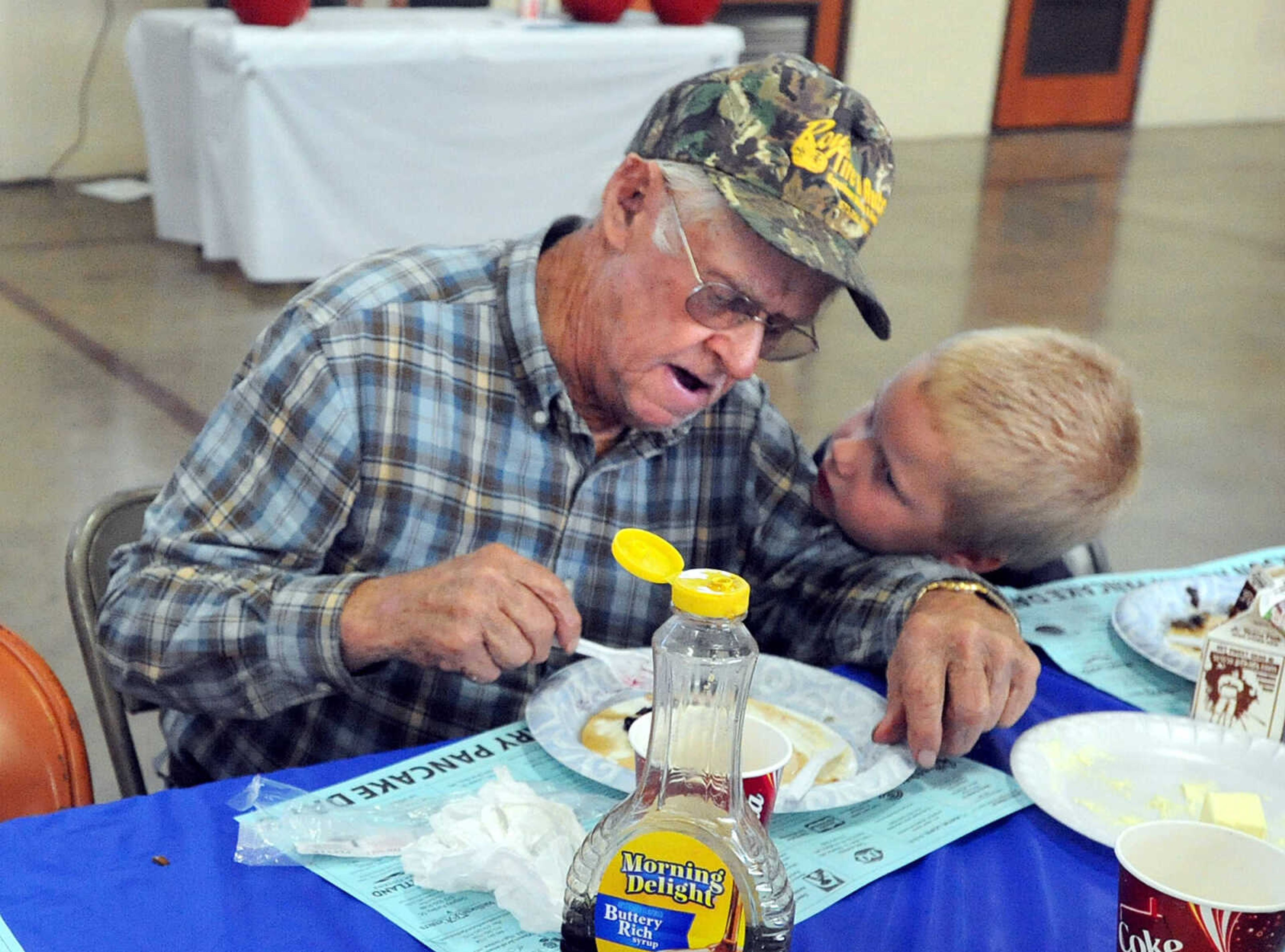 LAURA SIMON ~ lsimon@semissourian.com
Nick Loenneke, 4, and Herman "Pa Pa" Zschiller visit over their pancake dinner Tuesday, Oct. 23, 2012 during the Jackson Rotary Pancake Day at the National Guard Armory. People could pick from plain, chocolate chip, pecan and blueberry pancakes and a side of sausage.