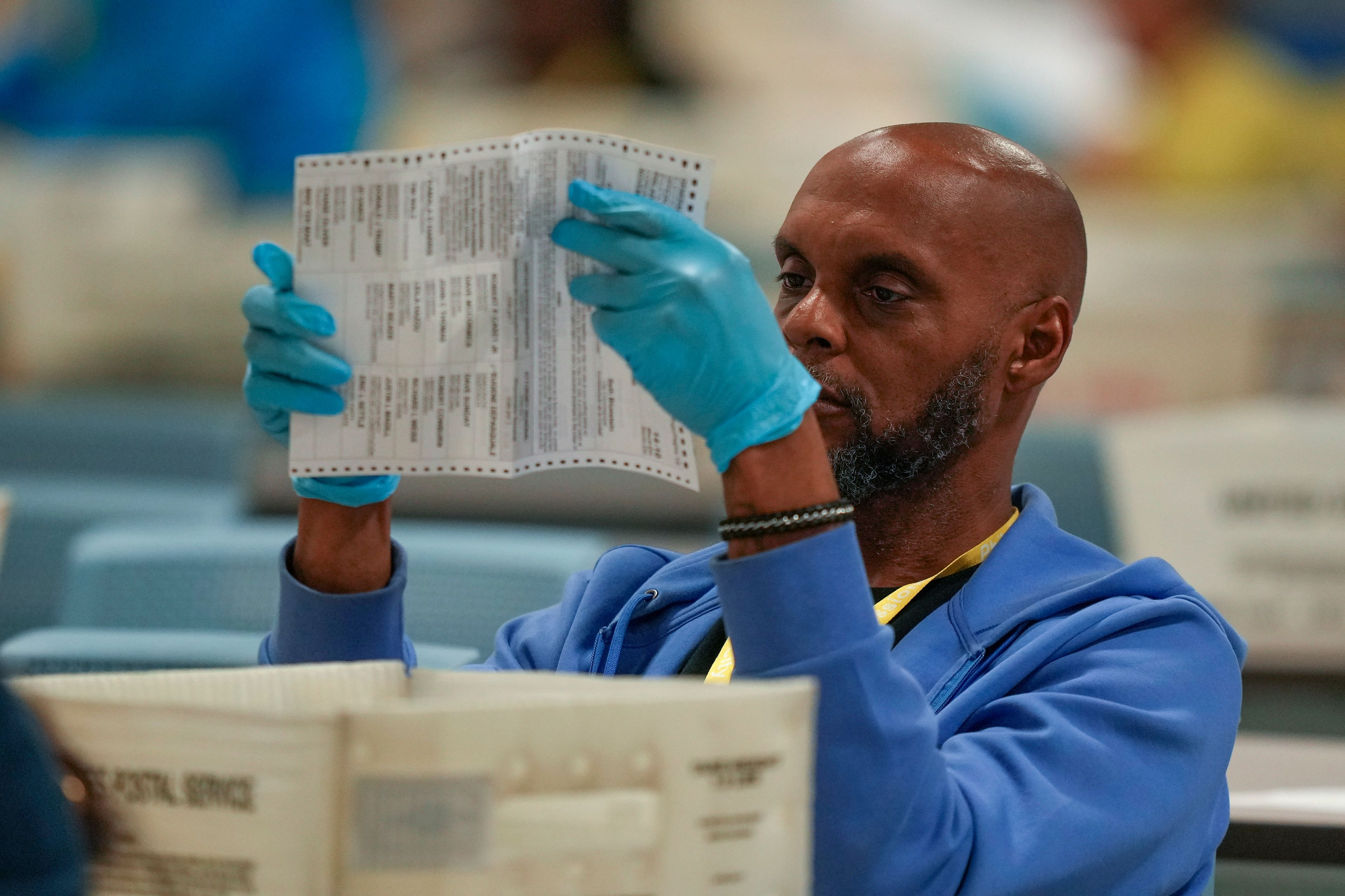 An election worker processes mail-in ballots for the 2024 General Election at the Philadelphia Election Warehouse, Tuesday, Nov. 5, 2024, in Philadelphia. (AP Photo/Matt Slocum)