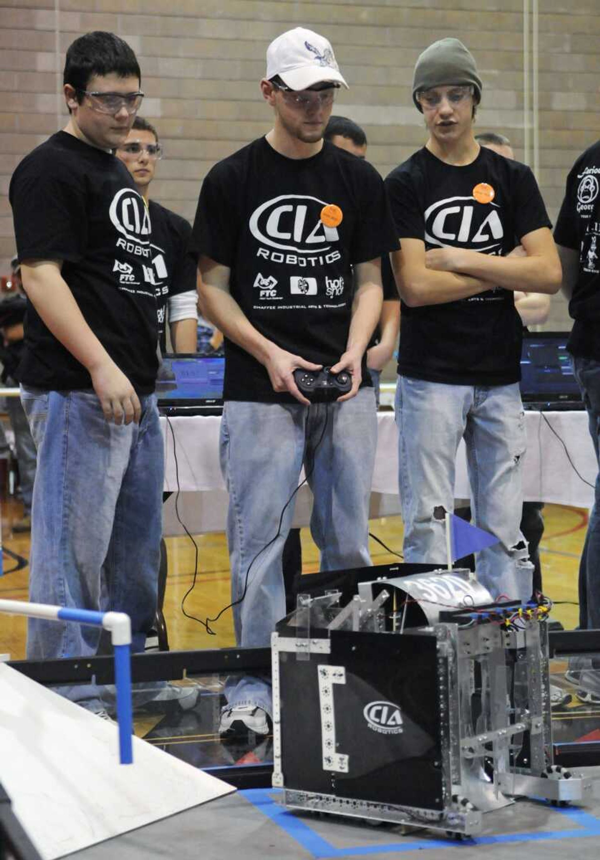 Chaffee, Missouri students Jared Walker, 15, Mitchell Dirnberger, 16, and Tucker Burton, 16, from left, members of Team 3630, named Furious George, compete in the final round of the The Cape Girardeau Regional FIRST Tech Challenge Competition at the Student Recreation Center in Cape Girardeau on Saturday, February 27, 2010. Team Furious George took first place in the competition, which involved constructing robots to compete in a basketball-like activity. (Kristin Eberts)