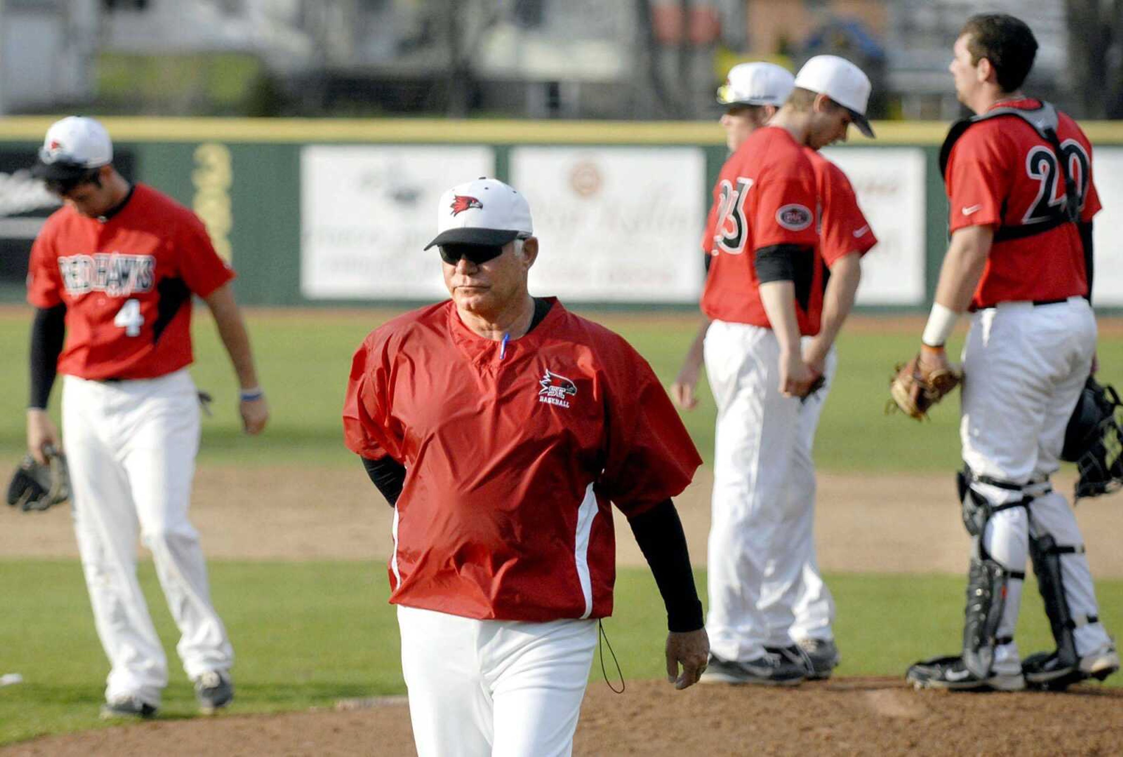 Southeast Missouri State coach Mark Hogan leaves the mound after a pitching change during a game at Capaha Field in March. (Laura Simon)