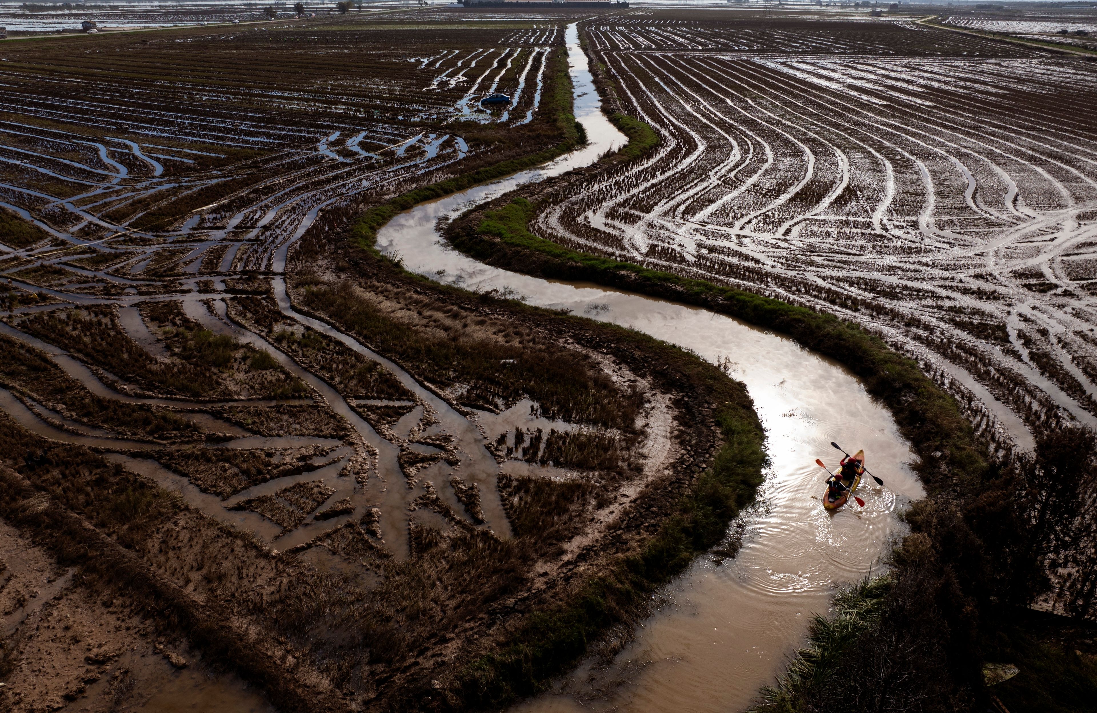 Members of the V battalion of the military emergency unit, UME, use a canoe to search the area for bodies washed away by the floods in the outskirts of Valencia, Spain, Friday, Nov. 8, 2024. (AP Photo/Emilio Morenatti)