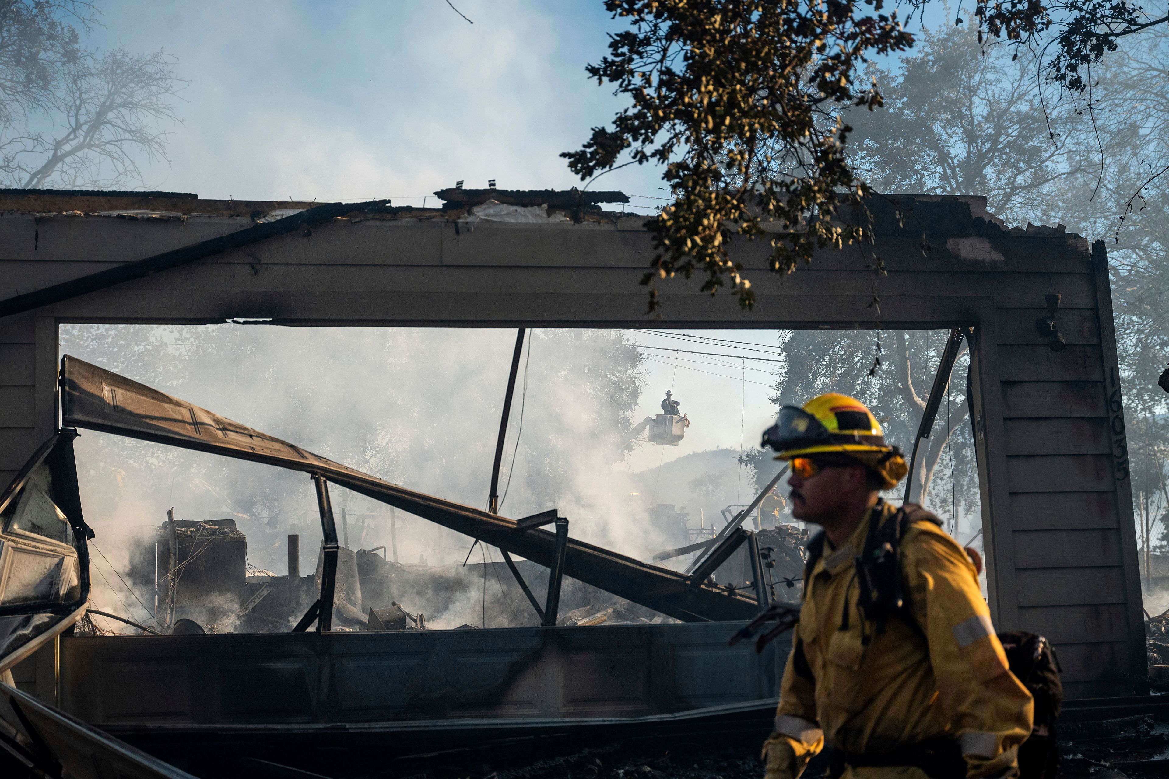 A firefighter passes a home destroyed by the Boyles fire in Clearlake, Calif., on Sunday, Sept. 8, 2024. (AP Photo/Noah Berger)