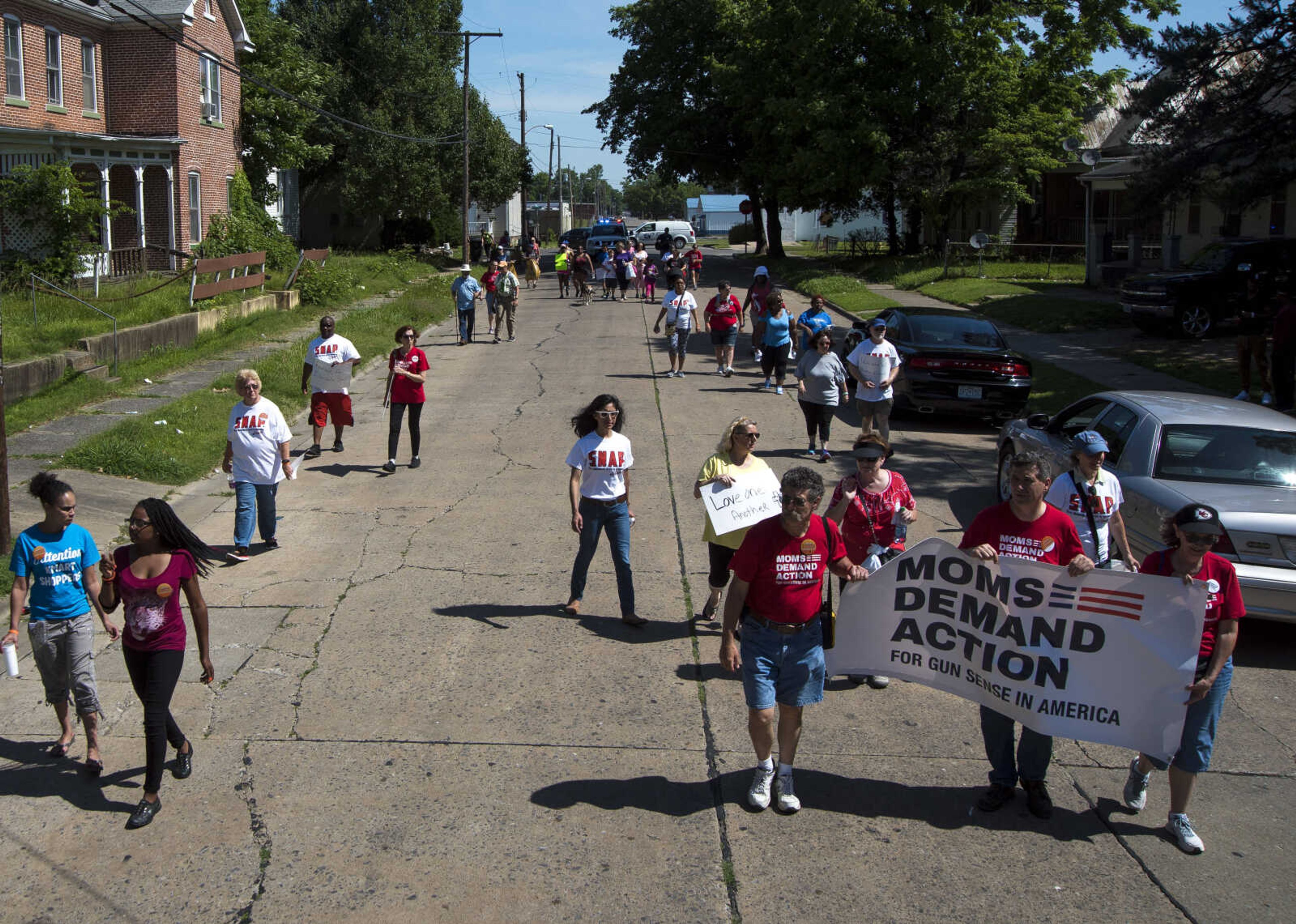 Community Members march during a Stop Needless Acts of Violence Please (SNAP) prayer march Saturday, June 10, 2017 in Cape Girardeau.