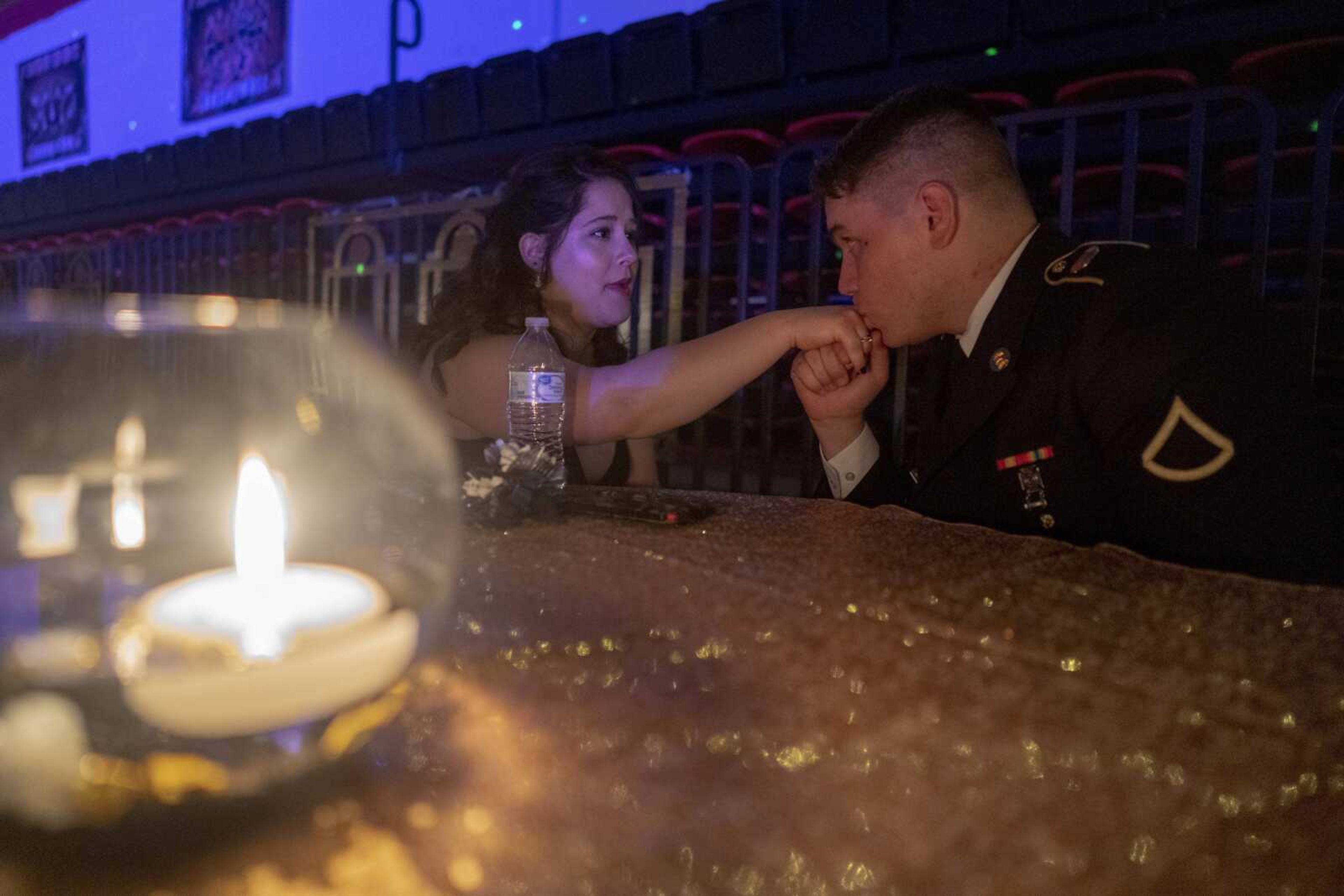 Ashton Derrow, a Jackson graduate and member of the National Guard, kisses the hand of Bella Carlson during prom Saturday, May 1, 2021 at Jackson High School.