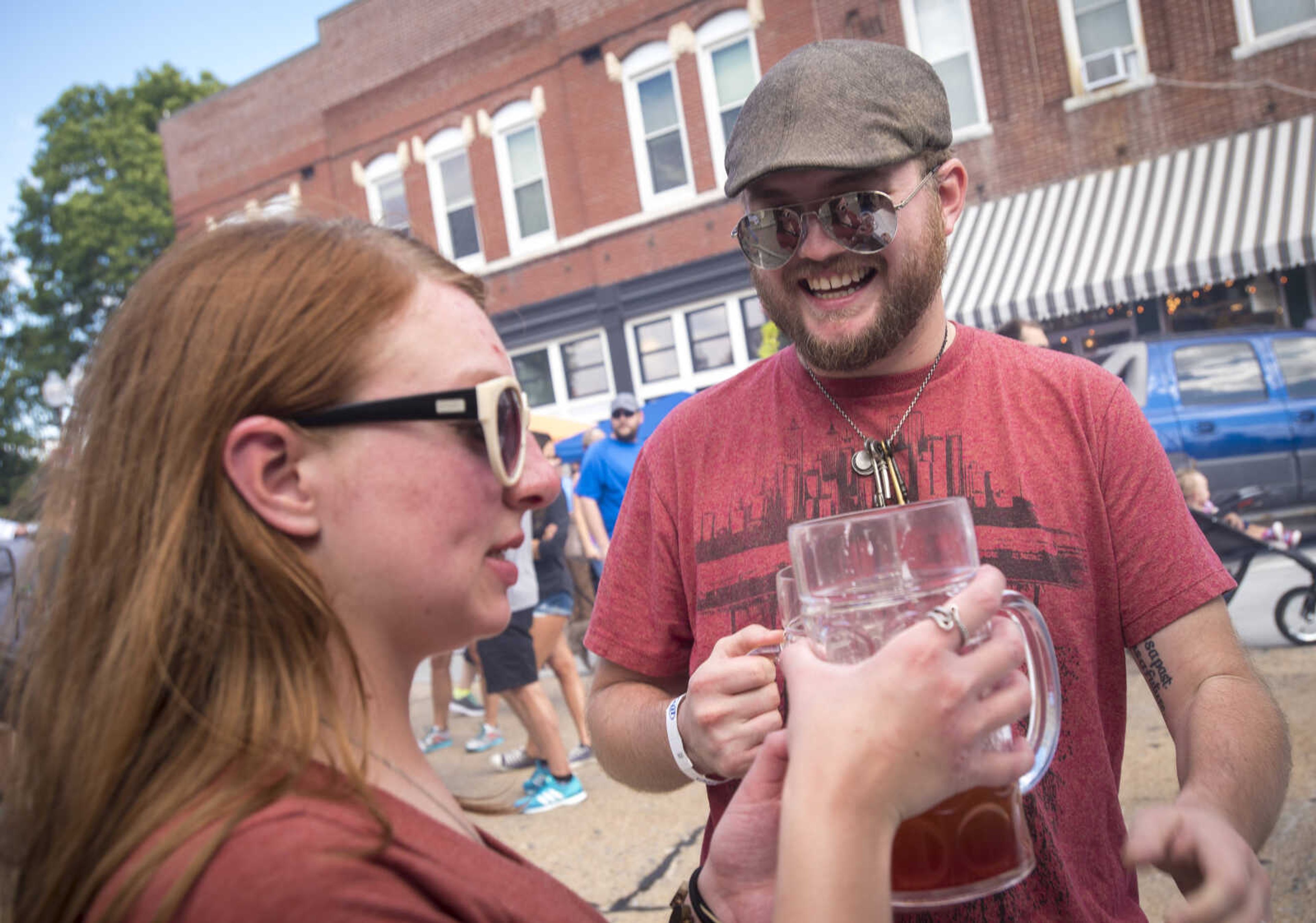 Amanda Camp and her husband Trevor Camp try each others beers at the Uptown Jackson Oktoberfest, Saturday, October 7, 2017.