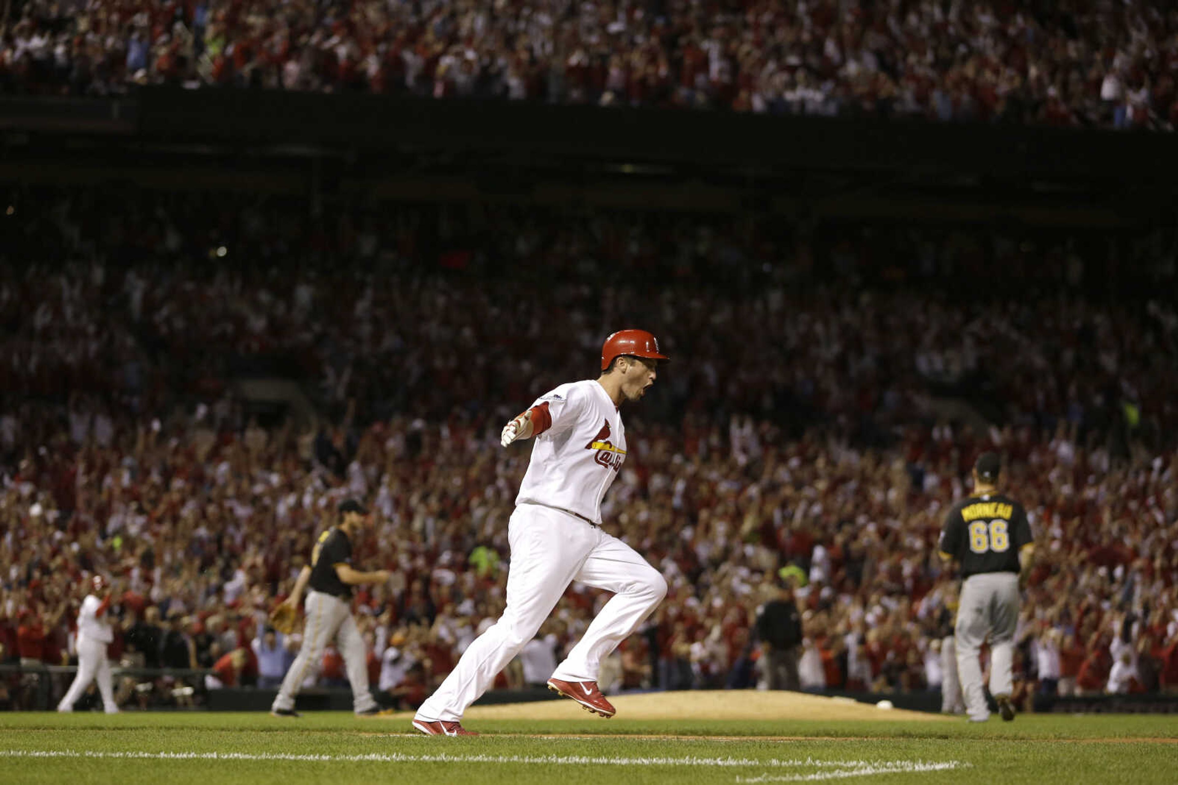 St. Louis Cardinals' David Freese runs to first base after hitting a two-run home run against the Pittsburgh Pirates in the second inning of Game 5 of a National League baseball division series on Wednesday, Oct. 9, 2013, in St. Louis. (AP Photo/Jeff Roberson)