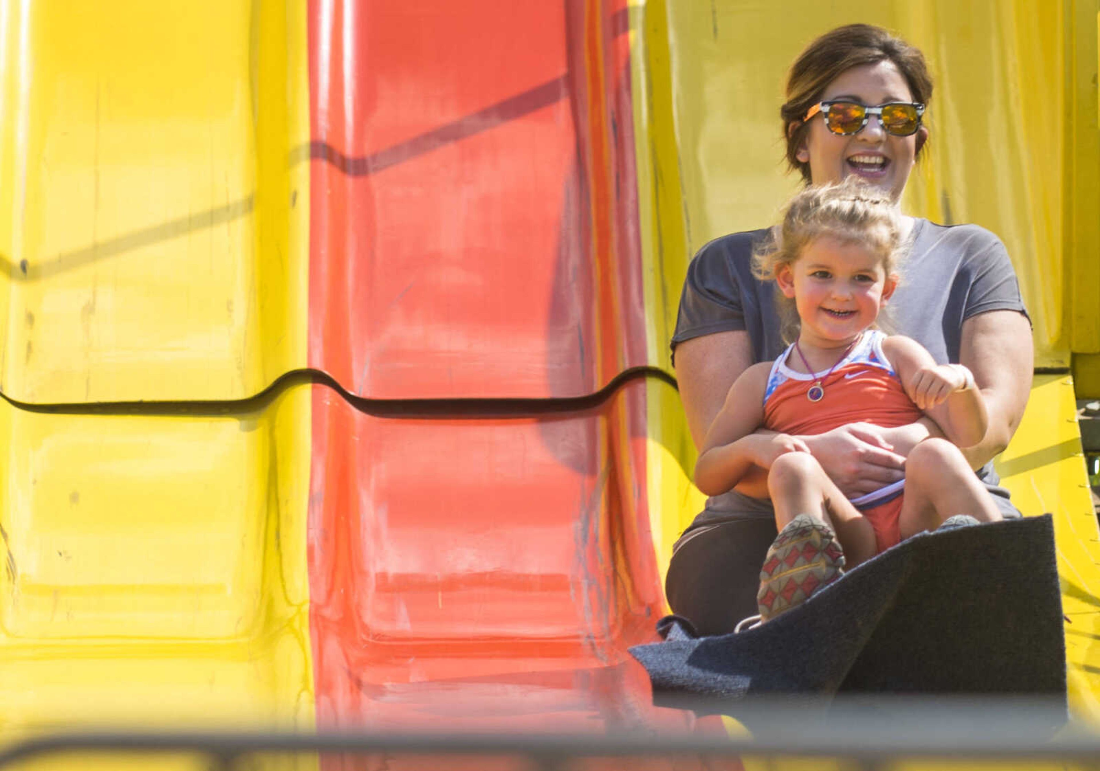 Jessica Schoen goes on the slides with her daughter, Aliyah, 3, on Sept. 23, 2017 at the East Perry Community Fair in Altenburg, Missouri.