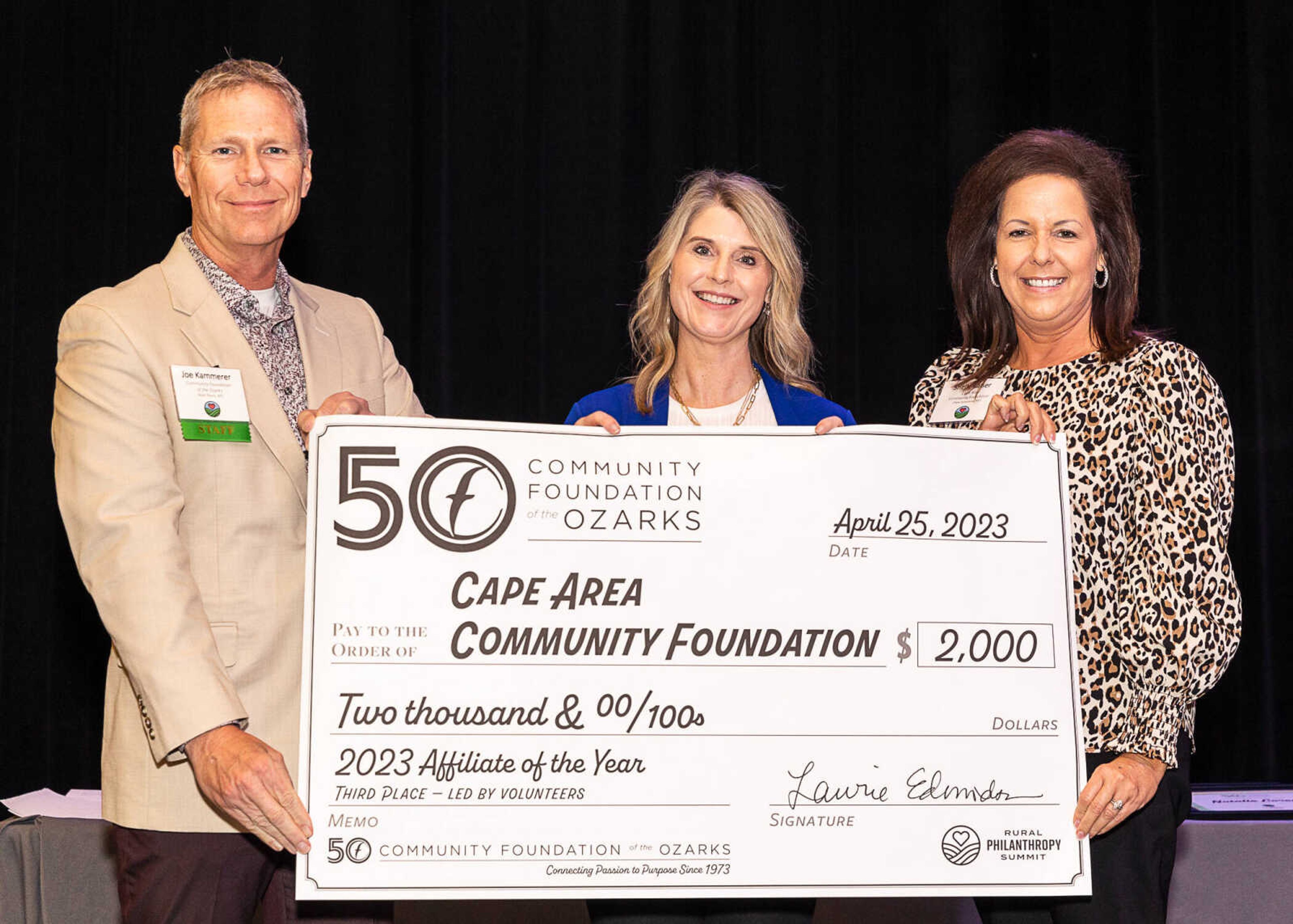 Joe Kammerer, central region manager for the Community Foundation of the Ozarks, presents a grant for $2,000 to Sara Gerau, board member of the Cape Area Community Foundation, and Shelly Kaiser, treasurer of the CACF. 