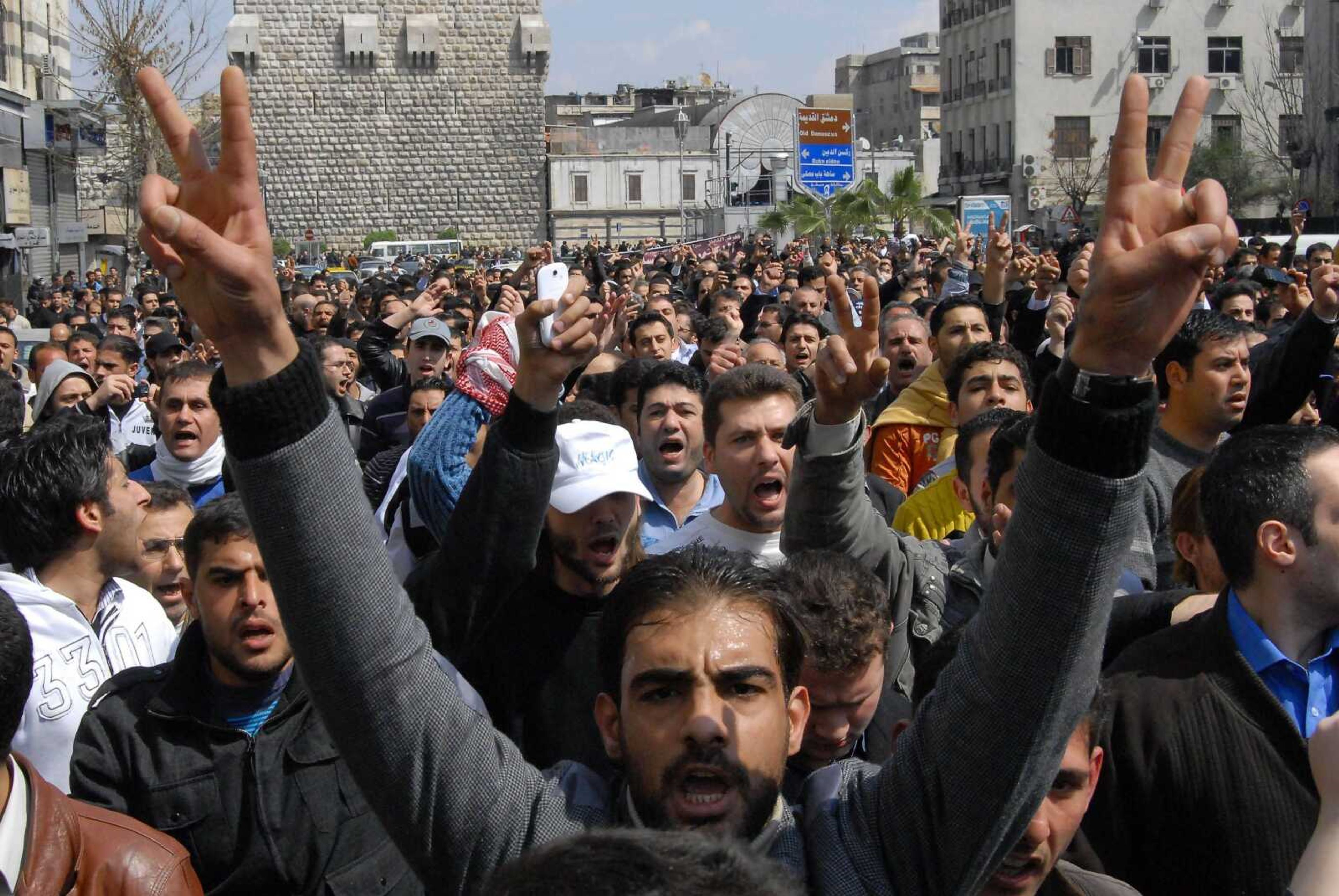 Anti-Syrian government protesters shout slogans as they protest after Friday prayers in Damascus, Syria. Thousands of Syrians took to the streets demanding reforms and mourning dozens of protesters who were killed during a weeklong crackdown. (Muzaffar Salman ~ Associated Press)