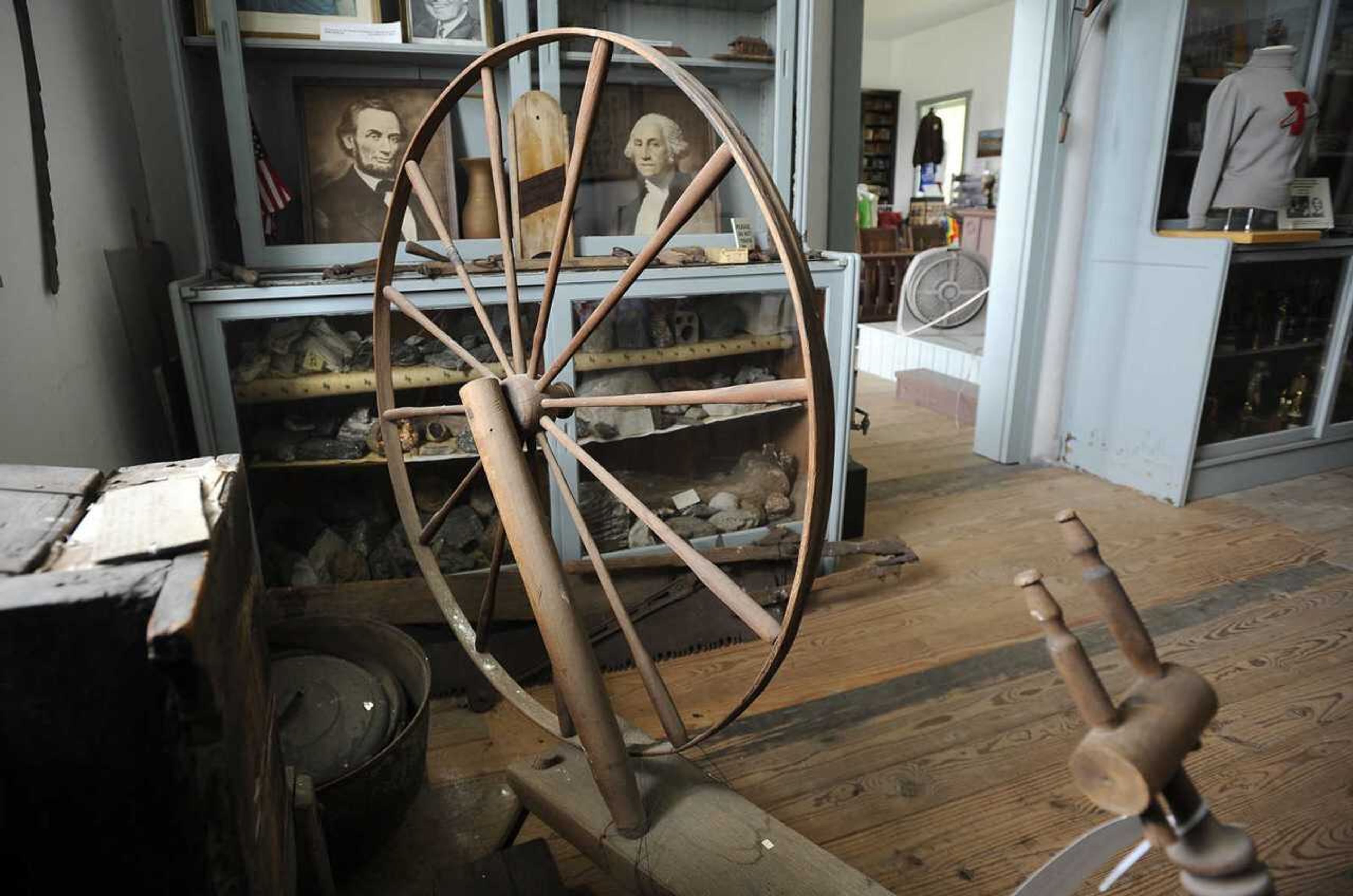 A portrait of Abraham Lincoln is seen behind a spinning wheel Aug. 18, 2018, in the historic courthouse in Thebes, Illinois, a community the 16th president is reported to have visited during his days as a trial lawyer, according to local legend.