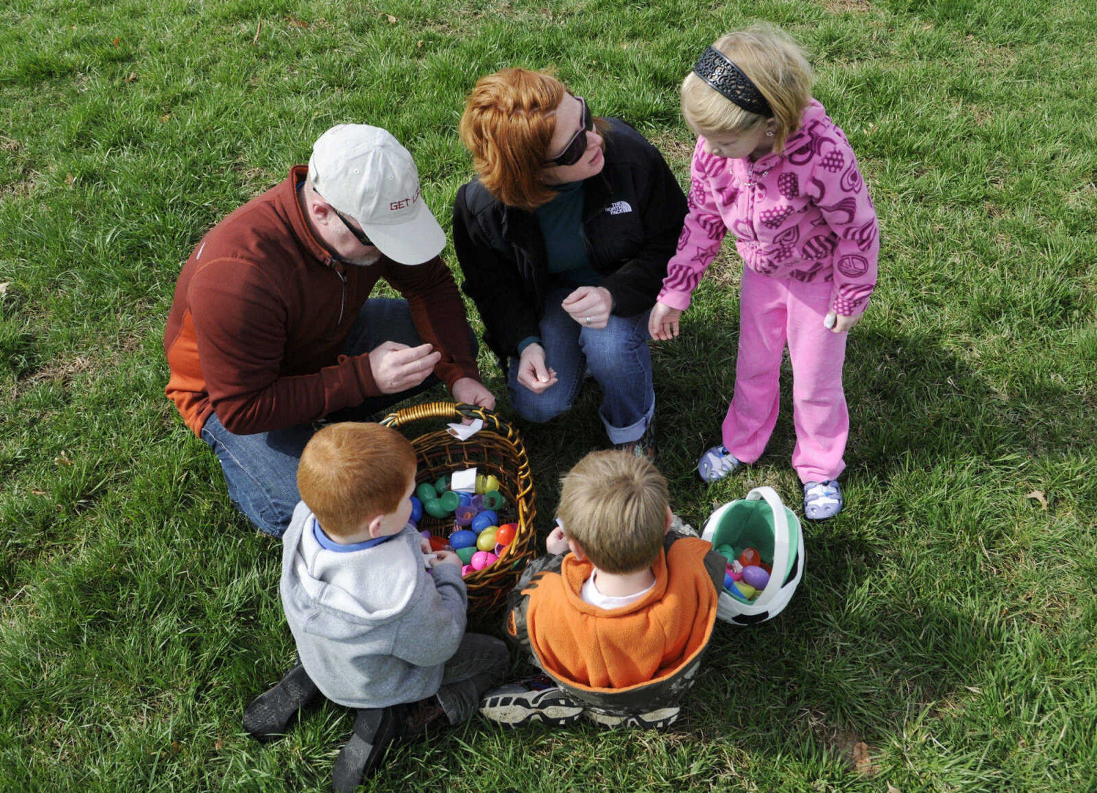 KRISTIN EBERTS ~ keberts@semissourian.com

Robert and Terri Cork help their children Harken Cork, 4, left, Savannah Cork, 6, right, and neighbor Braden Peck, 4, center, sort out the contents of their eggs after the Cape Girardeau Parks and Recreation easter egg hunt at Kiwanis Park in Cape Girardeau, Mo., on Saturday, March 27, 2010.