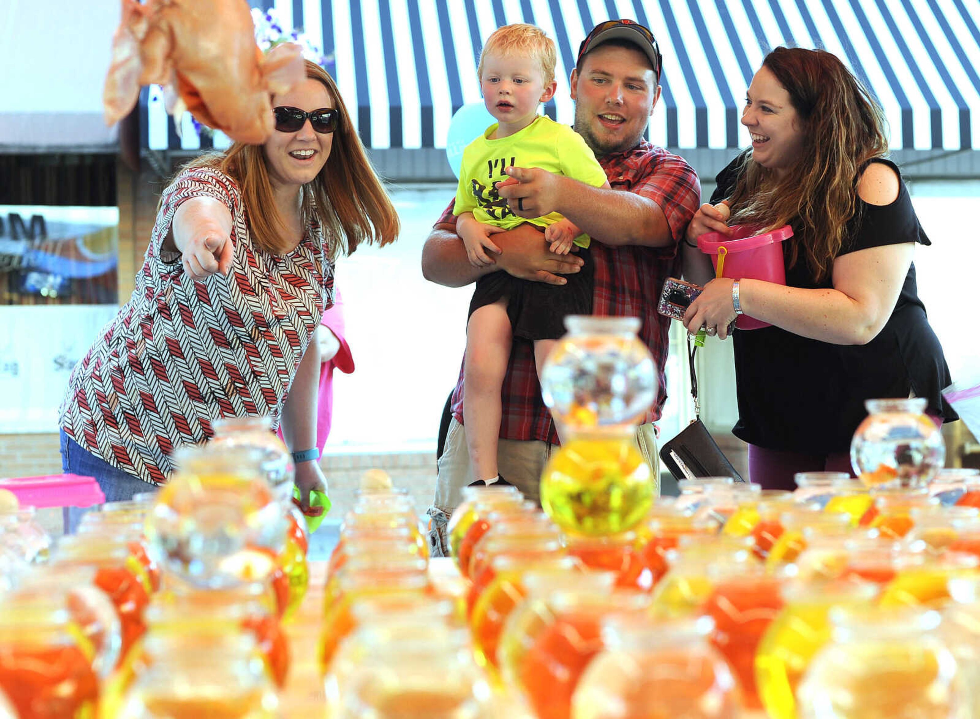 FRED LYNCH ~ flynch@semissourian.com
Grayson Gantz, 3, scores another goldfish, one of three, Tuesday, July 24, 2018, as his mother, Michaella Gantz, left, uncle Brandon Lane and aunt Mariah Lane cheer his success on the midway at Homecomers in Jackson.