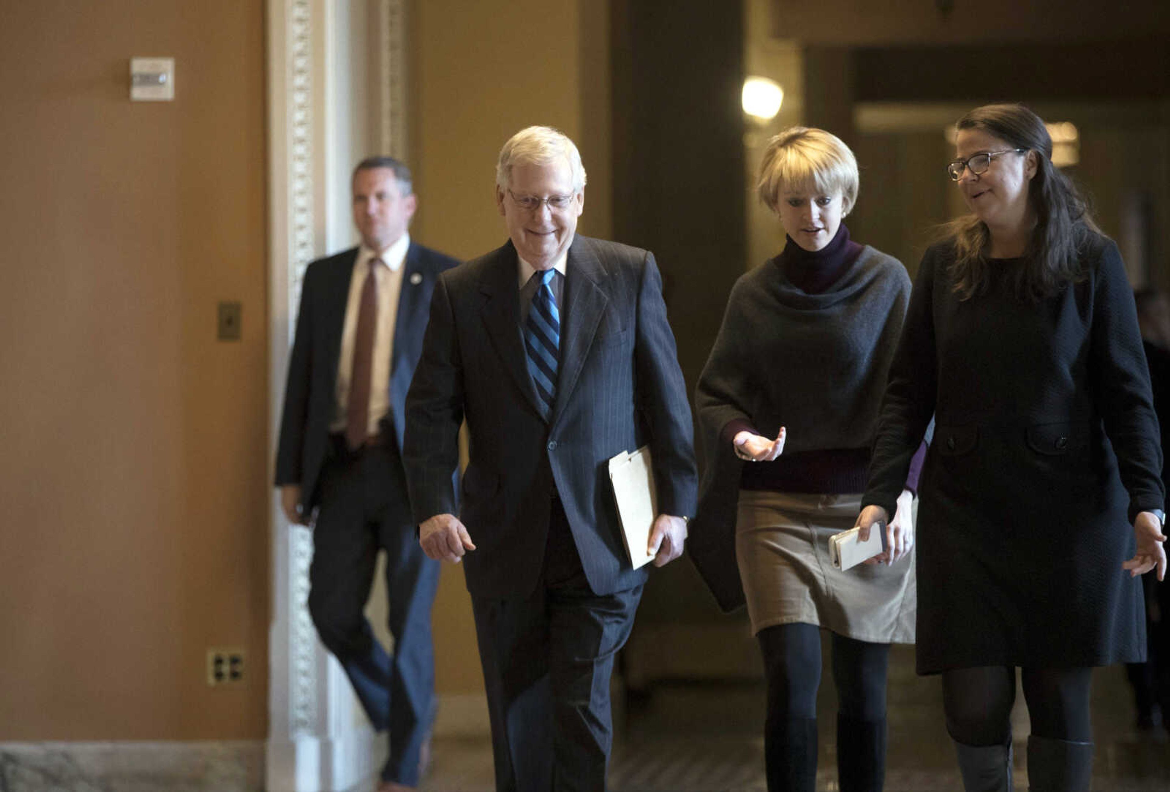 Senate Majority Leader Mitch McConnell, R-Ky., returns to chamber as the federal shutdown enters Day 2 amid a partisan blame game on both sides, at the Capitol on Sunday in Washington.