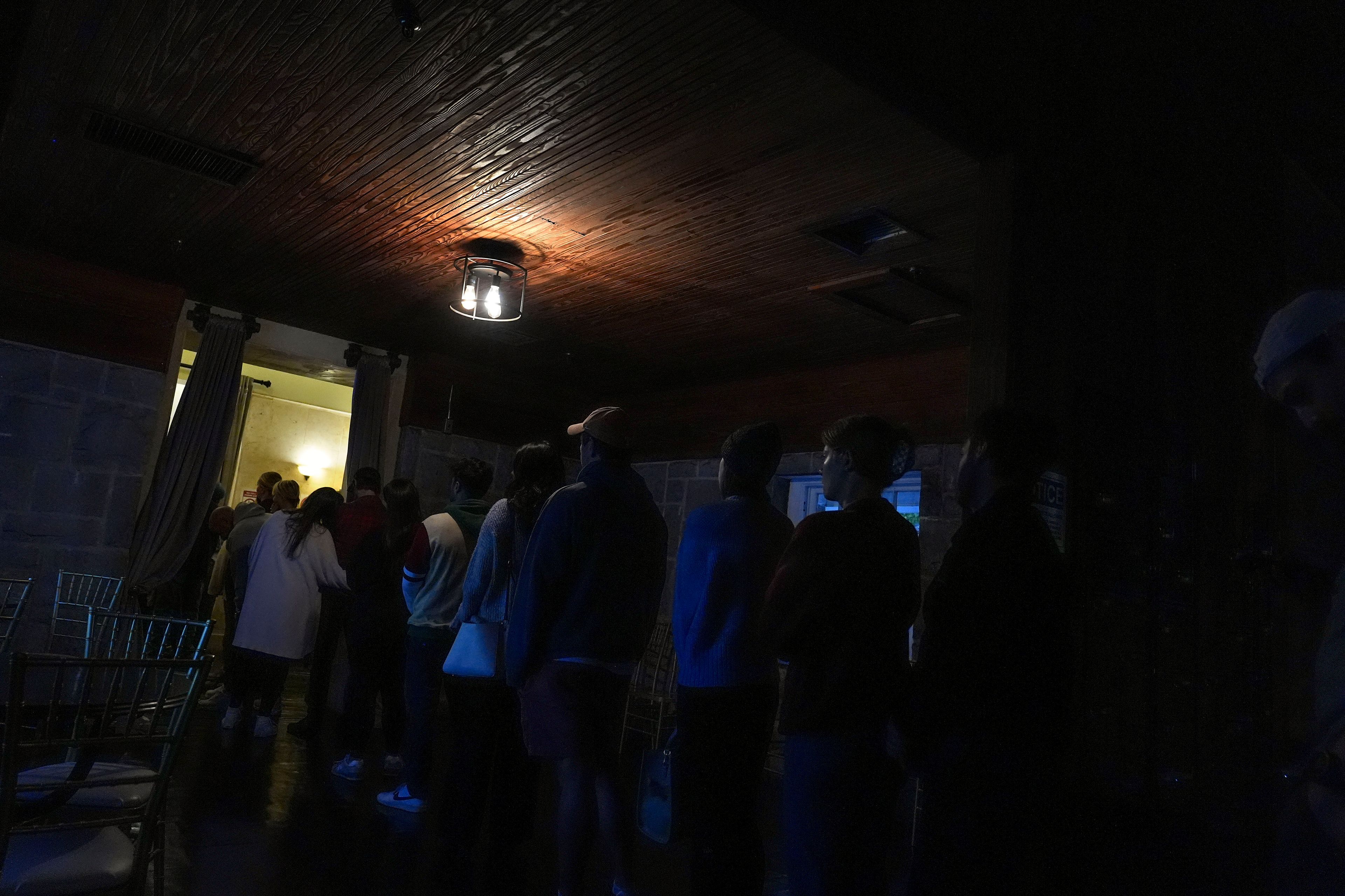 Voters stand in line to vote at a polling place inside Park Tavern, Tuesday, Nov. 5, 2024, in Atlanta. (AP Photo/Brynn Anderson)