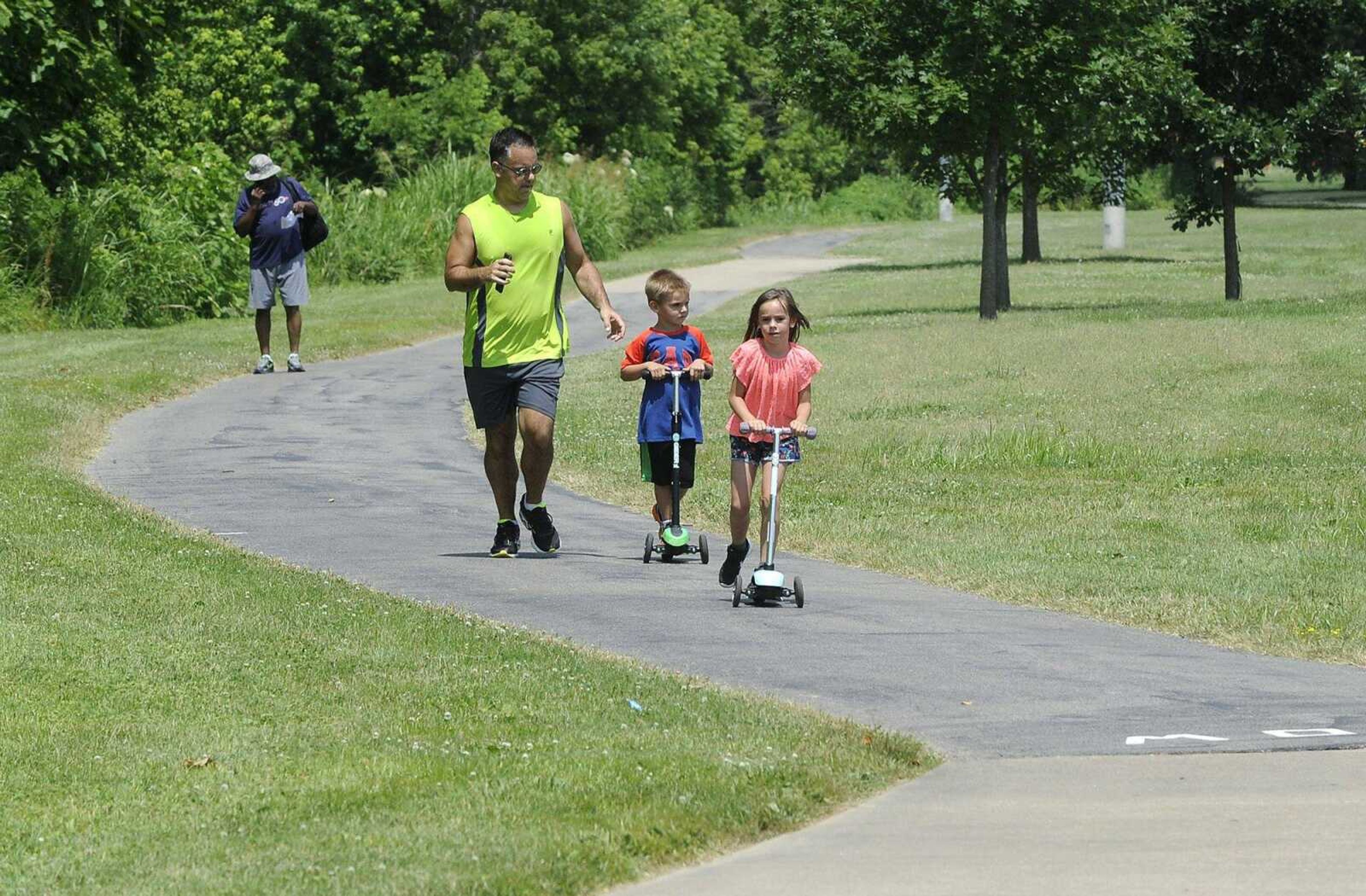 Mike Ogle enjoys some exercise with his son, Dane, and daughter, McCartney, on June 14, 2017, along the Cape LaCroix Recreation Trail, just west of East Rodney Drive in Cape Girardeau.