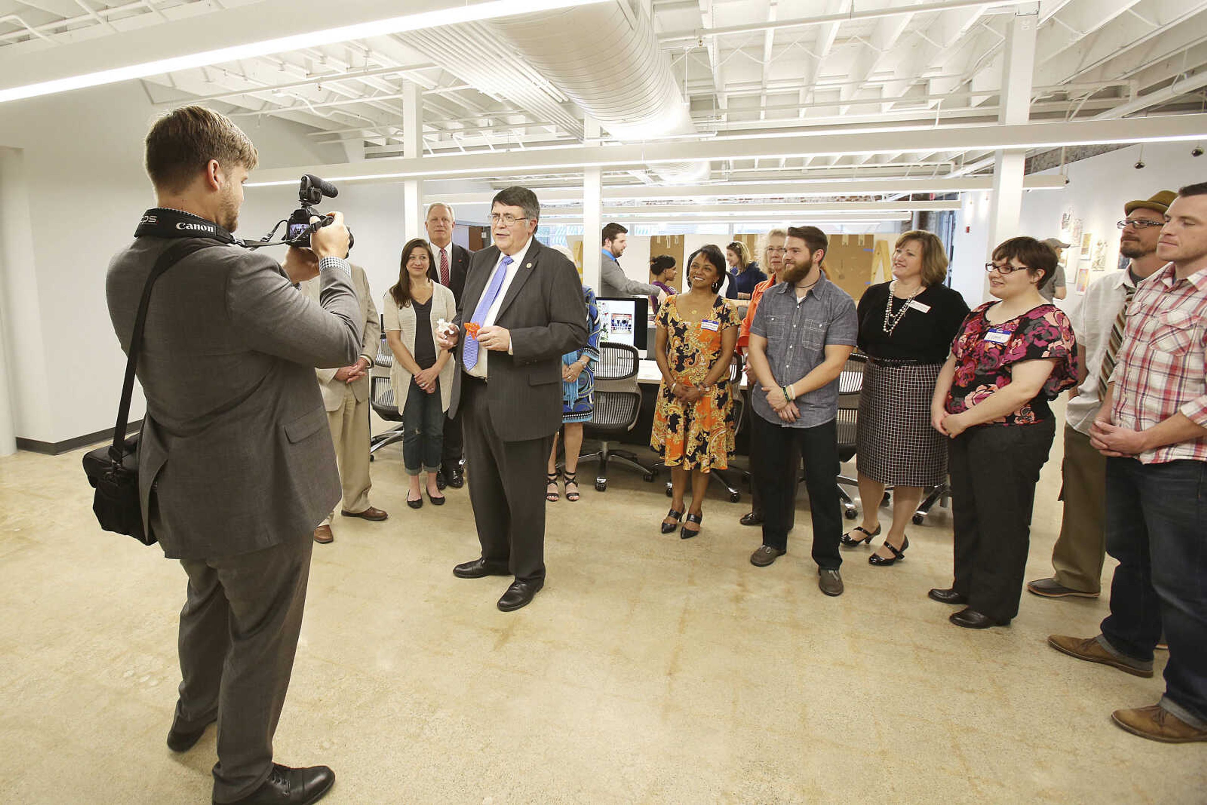 Hundreds attended the open reception for Catapult Creative House, Southeast Missouri State University's groundbreaking creative arts and industries incubator, at 612 S. Broadway Friday night, May 1, 2015, marking the launch of a commercial learning laboratory where creativity, innovation and entrepreneurship will converge, bringing novel products and services with a sustainable twist and local connection to market in a modern commercial marketplace. Dr. Kenneth W. Dobbins, president of Southeast Missouri State University, speaking, with members of a collaborative team of faculty members and local businesses, shared the need to educate students for a creative economy that is changing the way people live, work and learn, where they think, invent and innovate.  Catapult is the result of an interdisciplinary collaboration involving 12 faculty members drawn from eight academic programs from four different colleges and local businesses collaborated to launch this multidisciplinary and experiential learning house. Friday evening showcased the students and practitioners in a variety of creative and innovative disciplines that often work in silos, now housed in the new space designed to bring ideas to life.