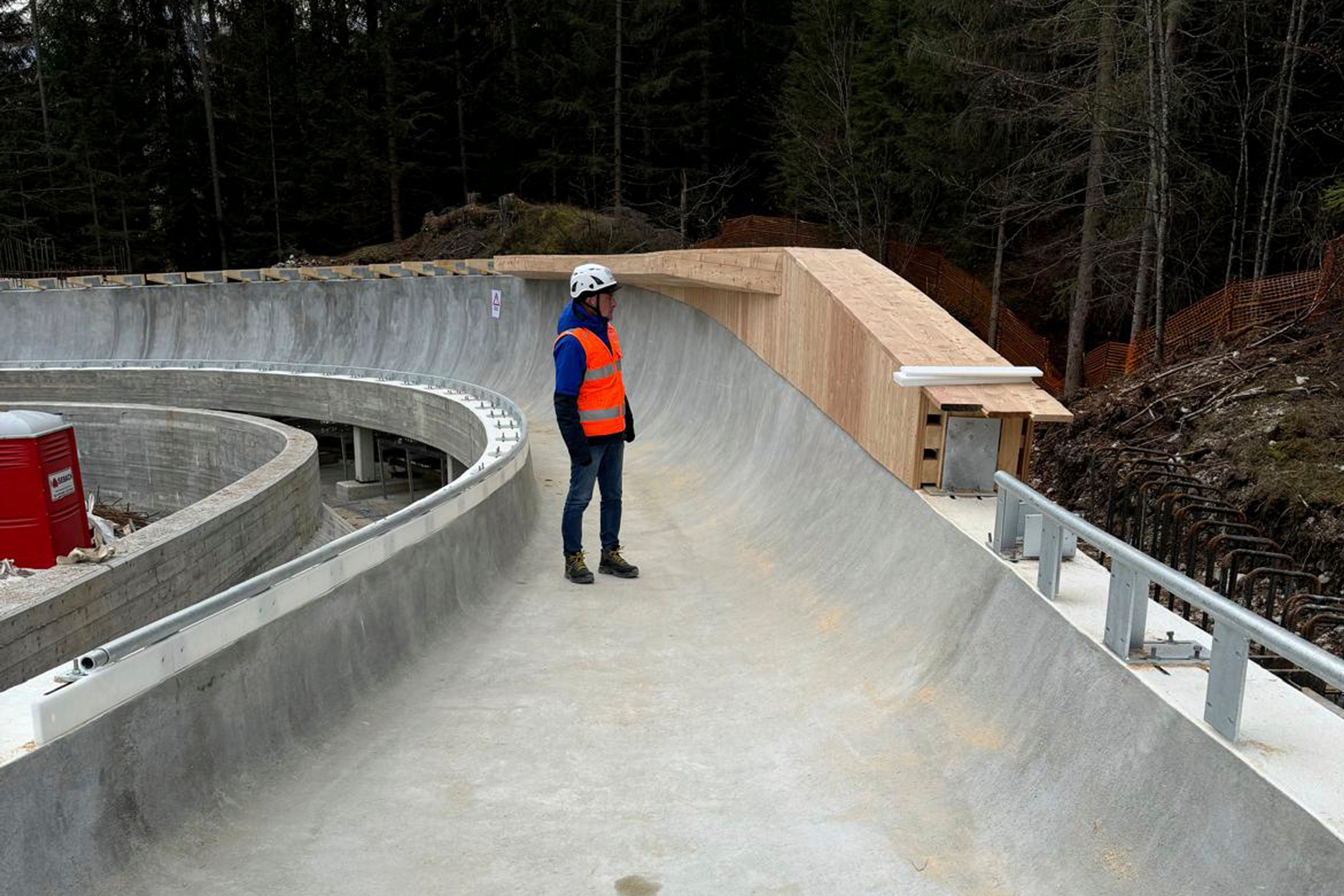 Government commissioner Fabio Saldini checks works at the sliding center for the 2026 Milan-Cortina Olympics in Cortina d'Ampezzo, Italy, Tuesday, Nov. 19, 2024. (Societa' Infrastrutture Milano Cortina via AP)