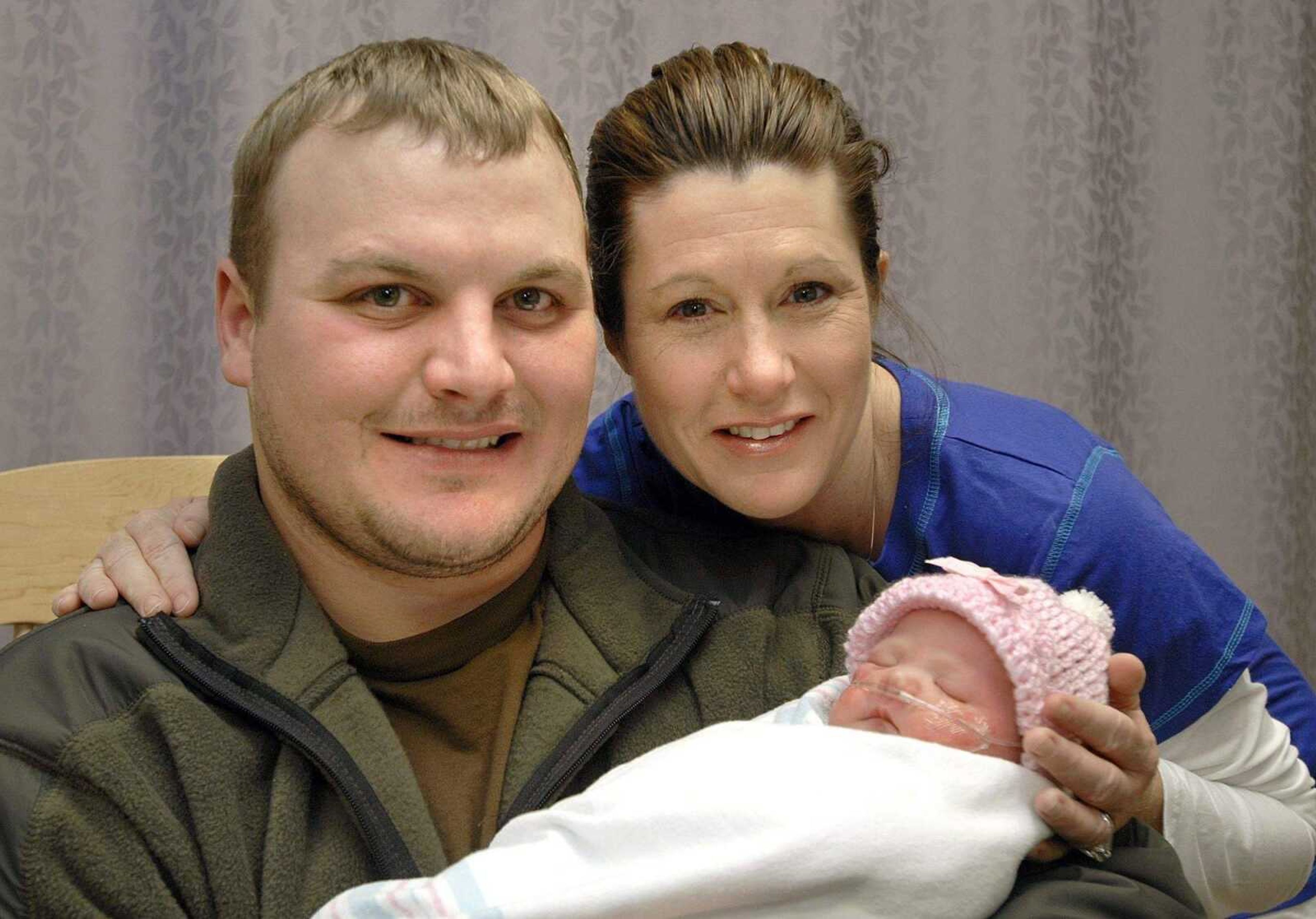 FRED LYNCH ~ flynch@semissourian.com<br>Wes and Tonya Amberger of Perryville, Mo. hold their new daughter, Abigail Marie, who was the first baby born on New Year's Day in Cape Girardeau. She was born at 3:36 a.m. Thursday at Southeast Missouri Hospital.