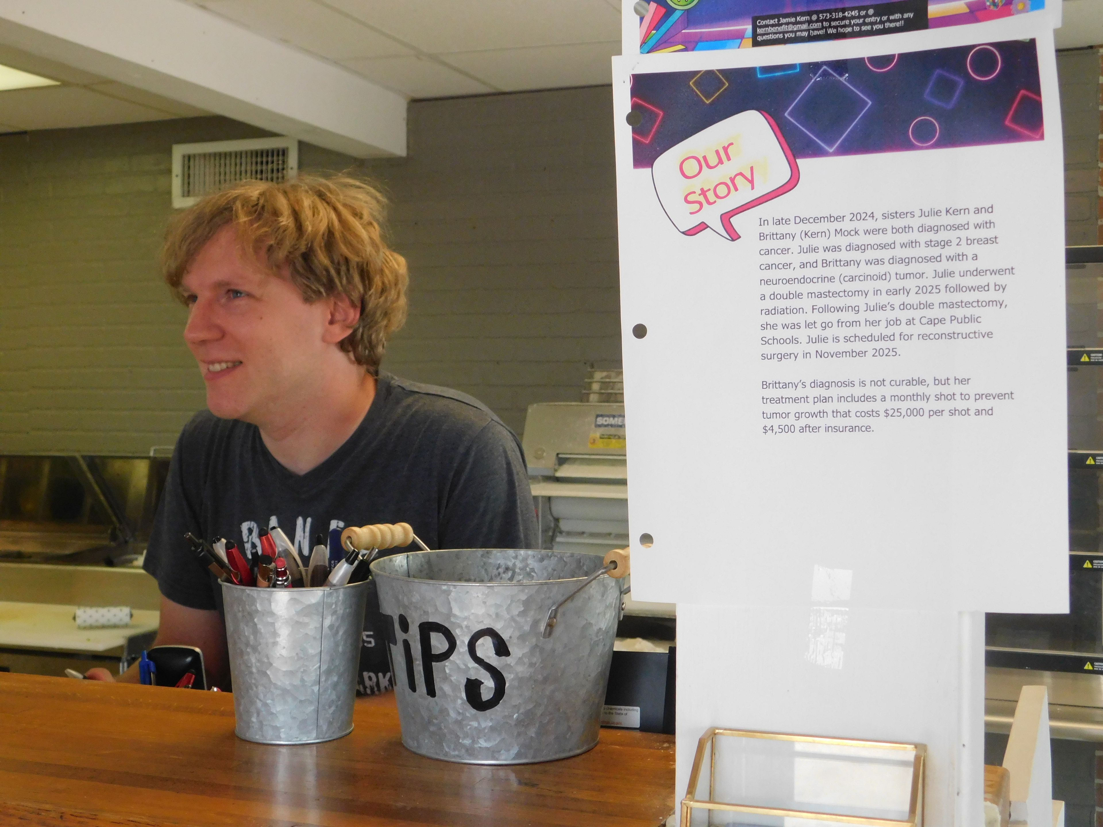 Alex Ballance displays a fundraiser notice to help two local women fighting cancer. The Scott City resident often hosts community fundraisers at his Pizza Pro restaurant at 2232 Main St.