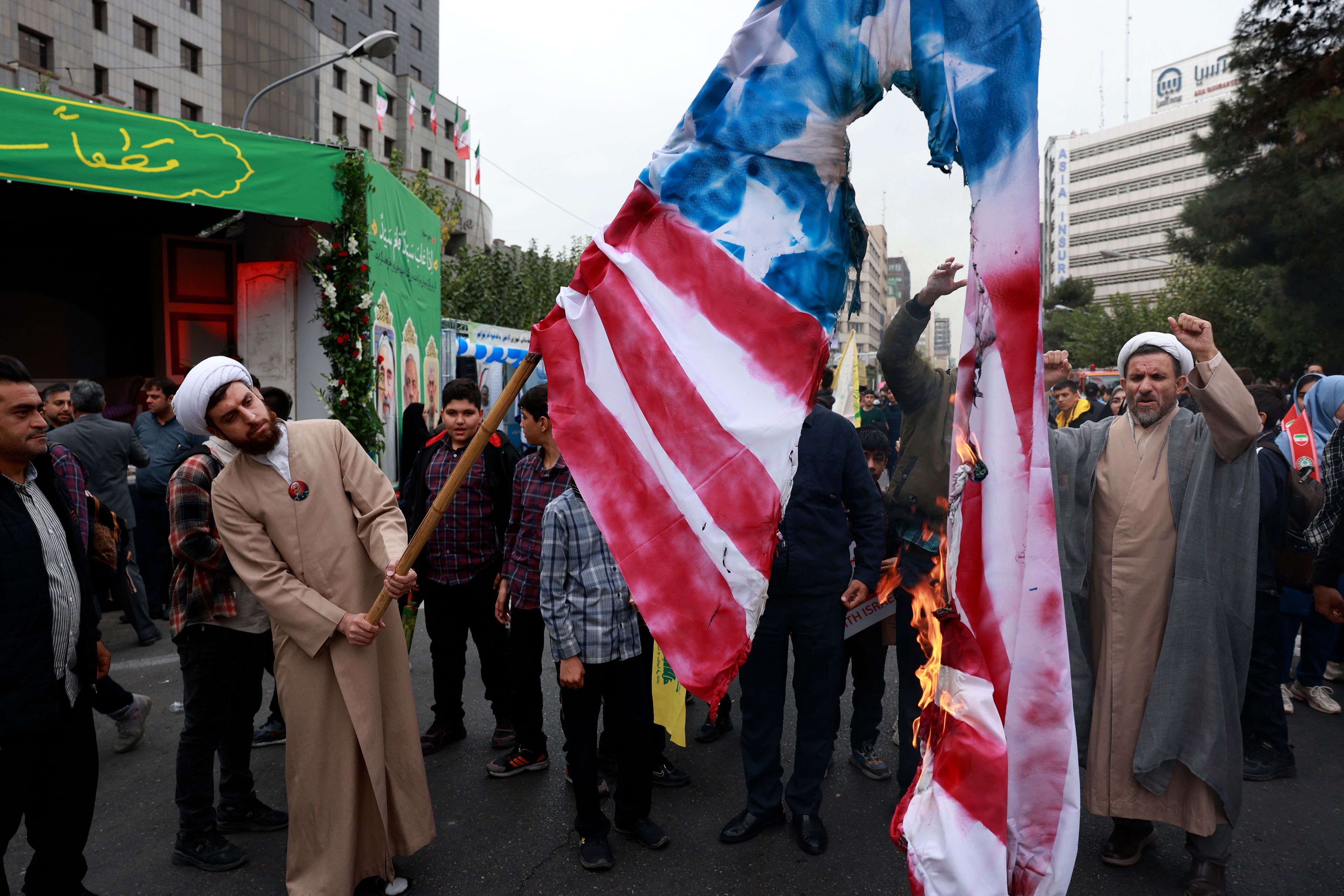 Iranian demonstrators burn a representation of the U.S. flag in an annual rally in front of the former U.S. Embassy in Tehran, Iran, Sunday, Nov. 3, 2024, marking the 45th anniversary of Iranian students' takeover of the embassy, starting a hostage crisis. (AP Photo/Vahid Salemi)