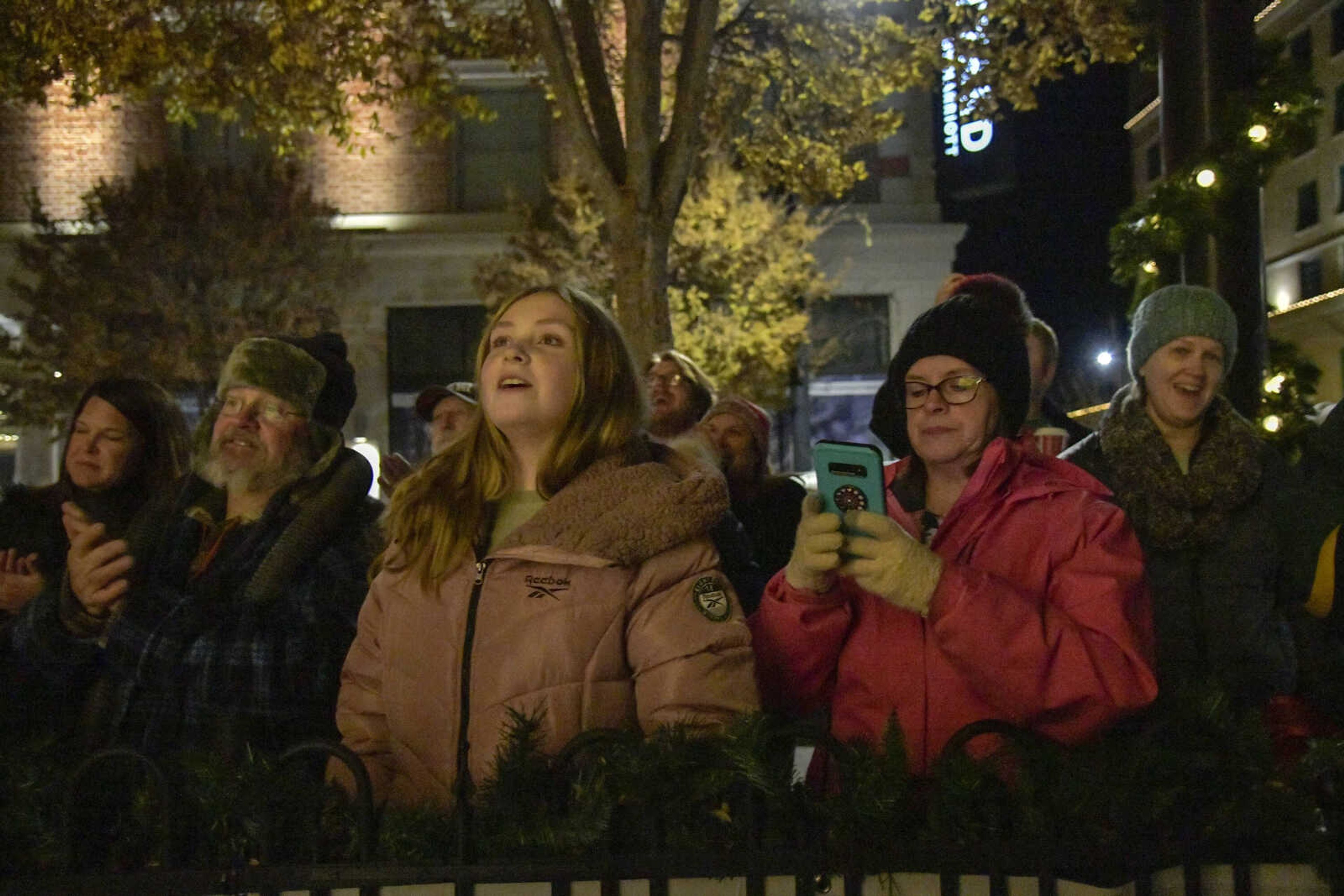 The crowd reacts to the tree being lit up for the first time during the 3rd Annual Old Town Cape Christmas Tree Lighting on Friday in Cape Girardeau.