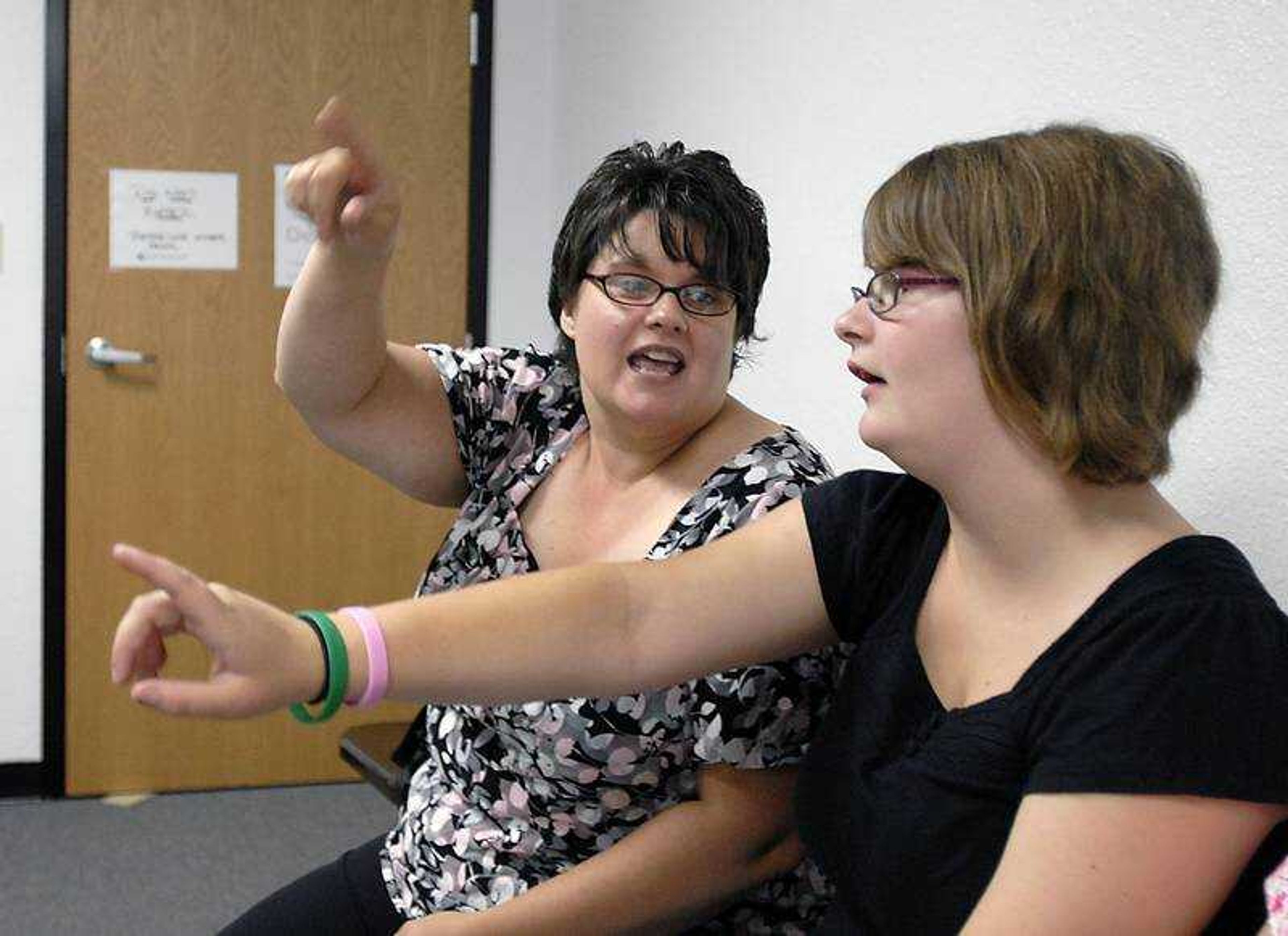 KIT DOYLE ~ kdoyle@semissourian.com
Pam Deneke, left, reviewed with Stacey Kohrman, 17, before Kohrman took the written driver's permit test Thursday in Cape Girardeau. Deneke, a special education teacher at Jackson High School, brought eight students who participate in the Wheels for Independence adaptive driver's education class through the district.