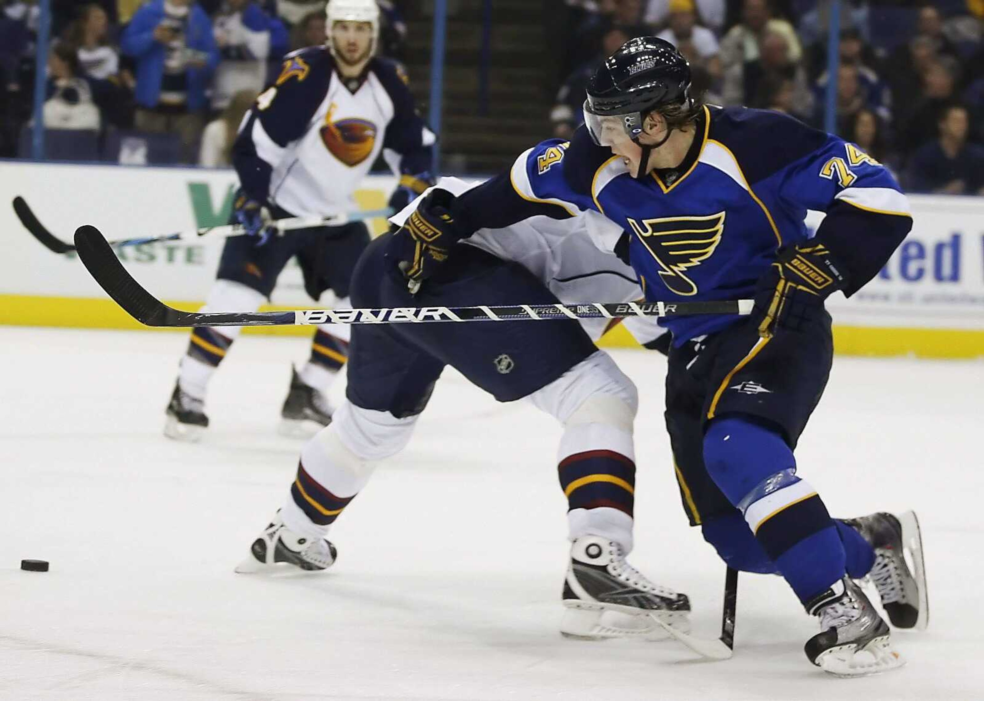 The Blues' T.J. Oshie gets past the Thrashers' Pavel Kubina during the second period Thursday in St. Louis. (Tom Gannam ~ Associated Press)