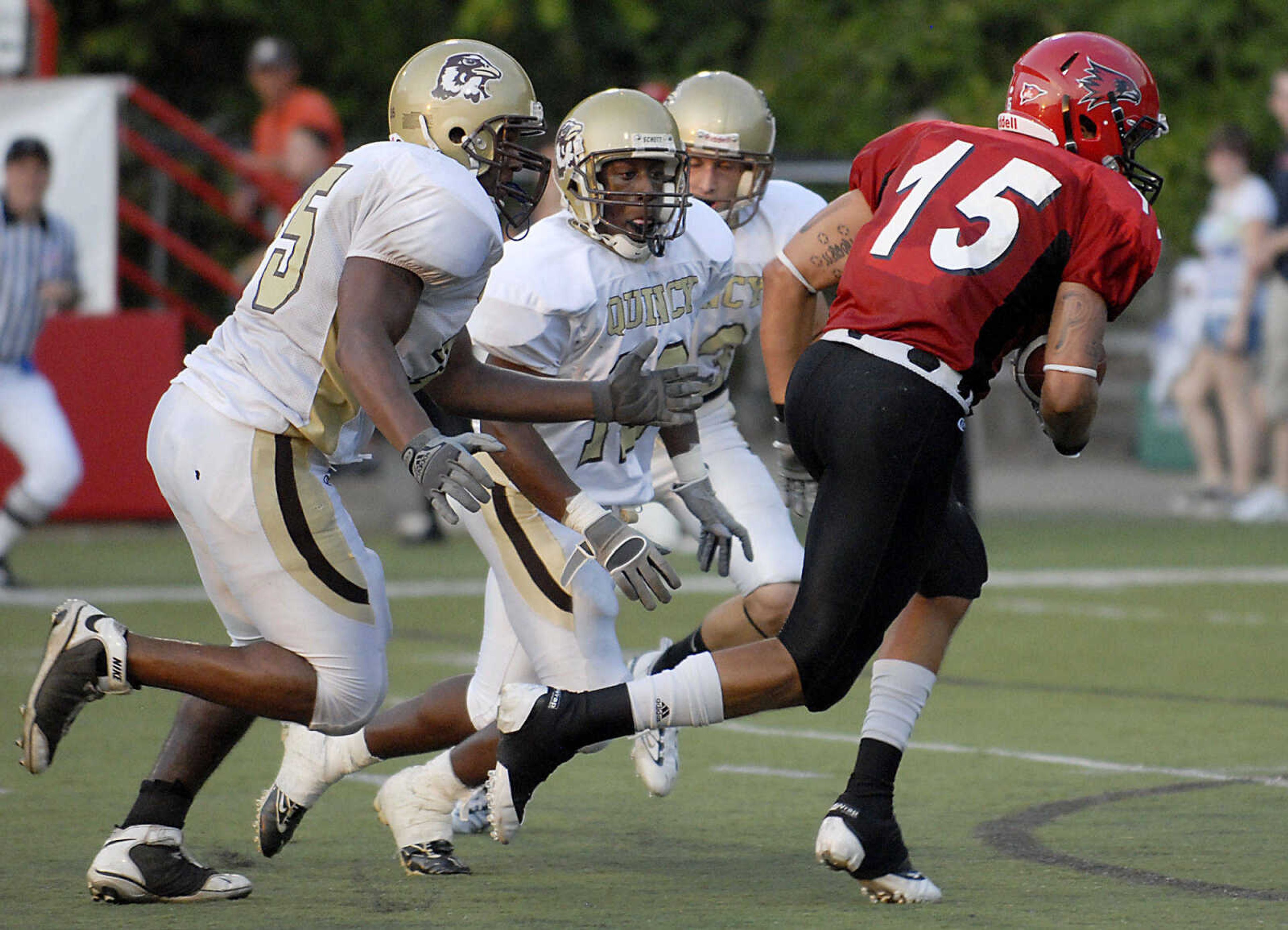 KIT DOYLE ~ kdoyle@semissourian.com
Quincy defenders close in on Walter Peoples Thursday, September 3, 2009, in the season opener at Houck Stadium.