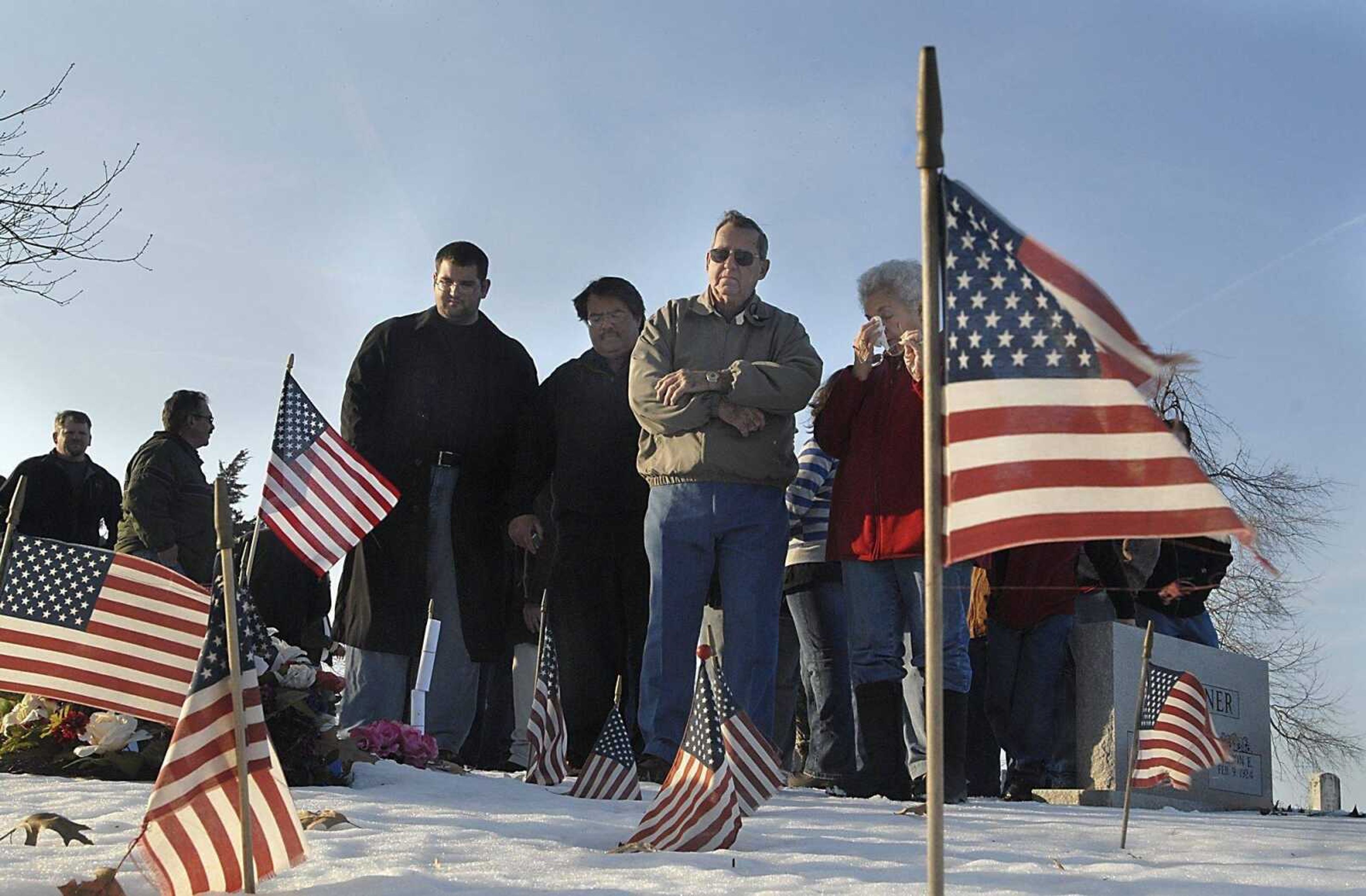 Carrie Skelton, right, dabs at her eyes while standing with her husband Charlie at the grave of their nephew Bradley Skelton Friday afternoon, February 6, 2009, at Christ Lutheran Church cemetery in Gordonville. More than 70 people attended the memorial service for Skelton, who died when hit by an IED while serving in Iraq one year beforehand. Skelton's cousins Bryan Skelton, left, and his father Keith Skelton. (Kit Doyle)