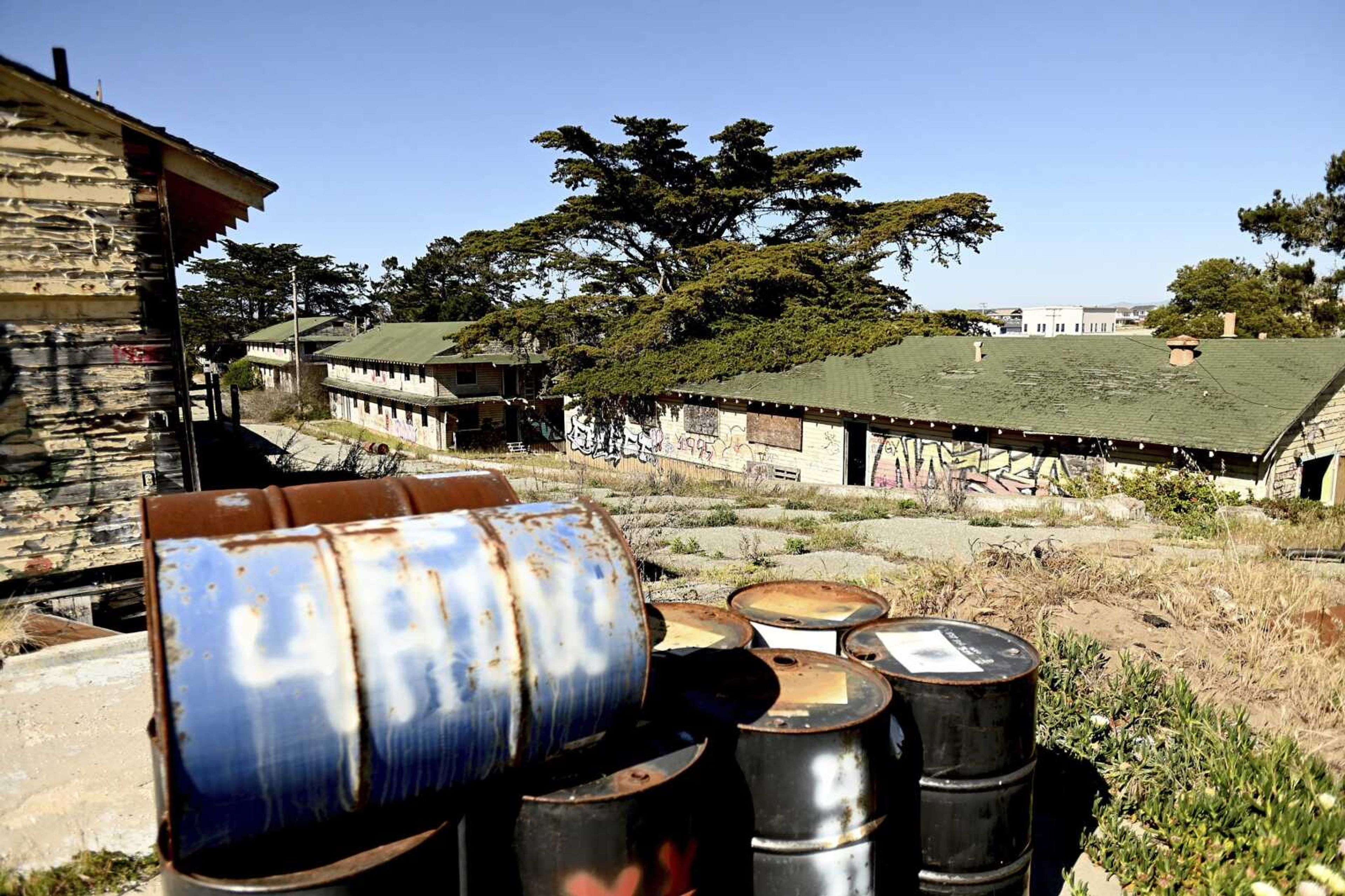 Rusted barrels rest outside barracks at Fort Ord on April 28, 2021, in Fort Ord, California.