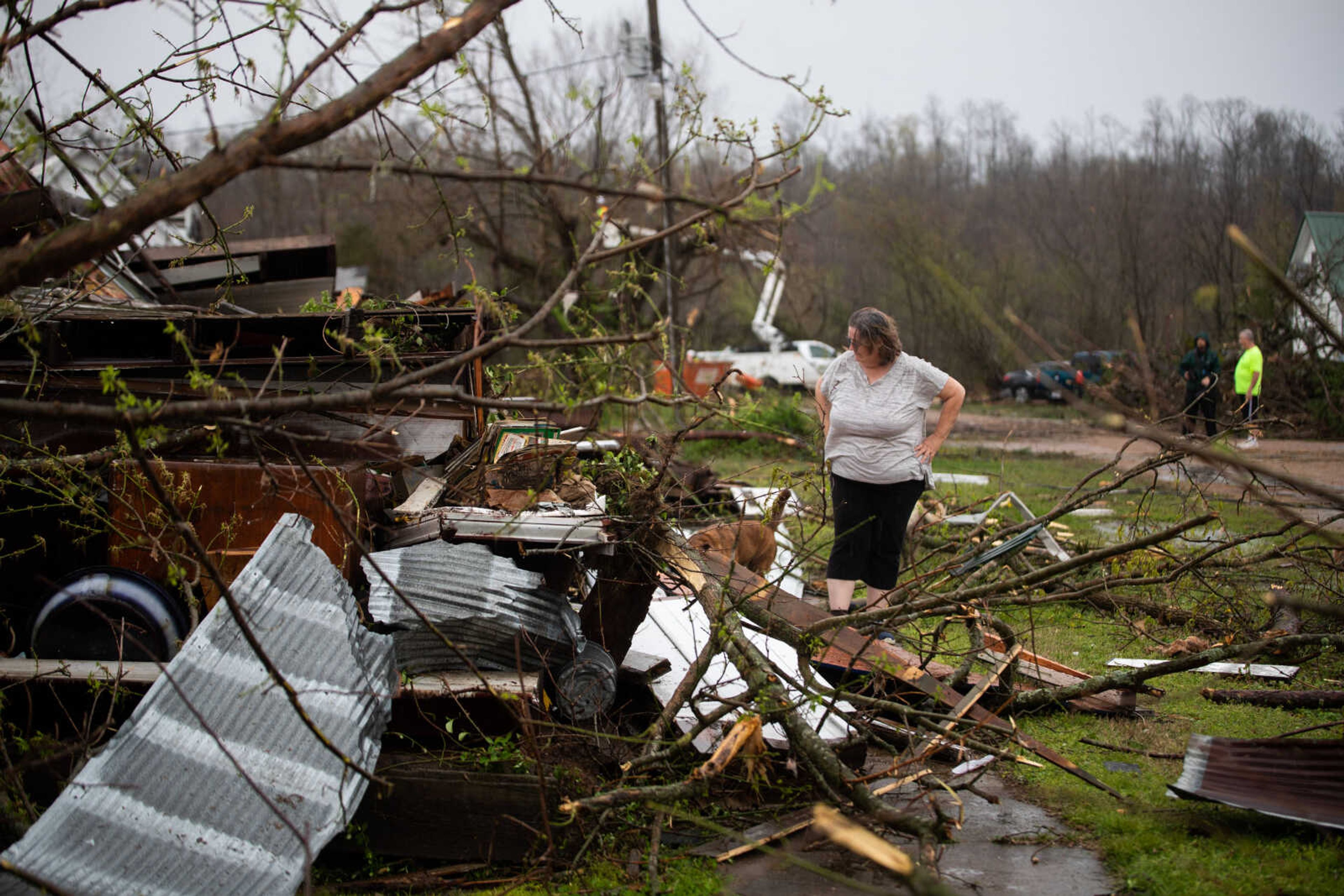 Patty Stanfilld-Seabaugh looks over one of her family's homes, which was completely destroyed by the tornado.