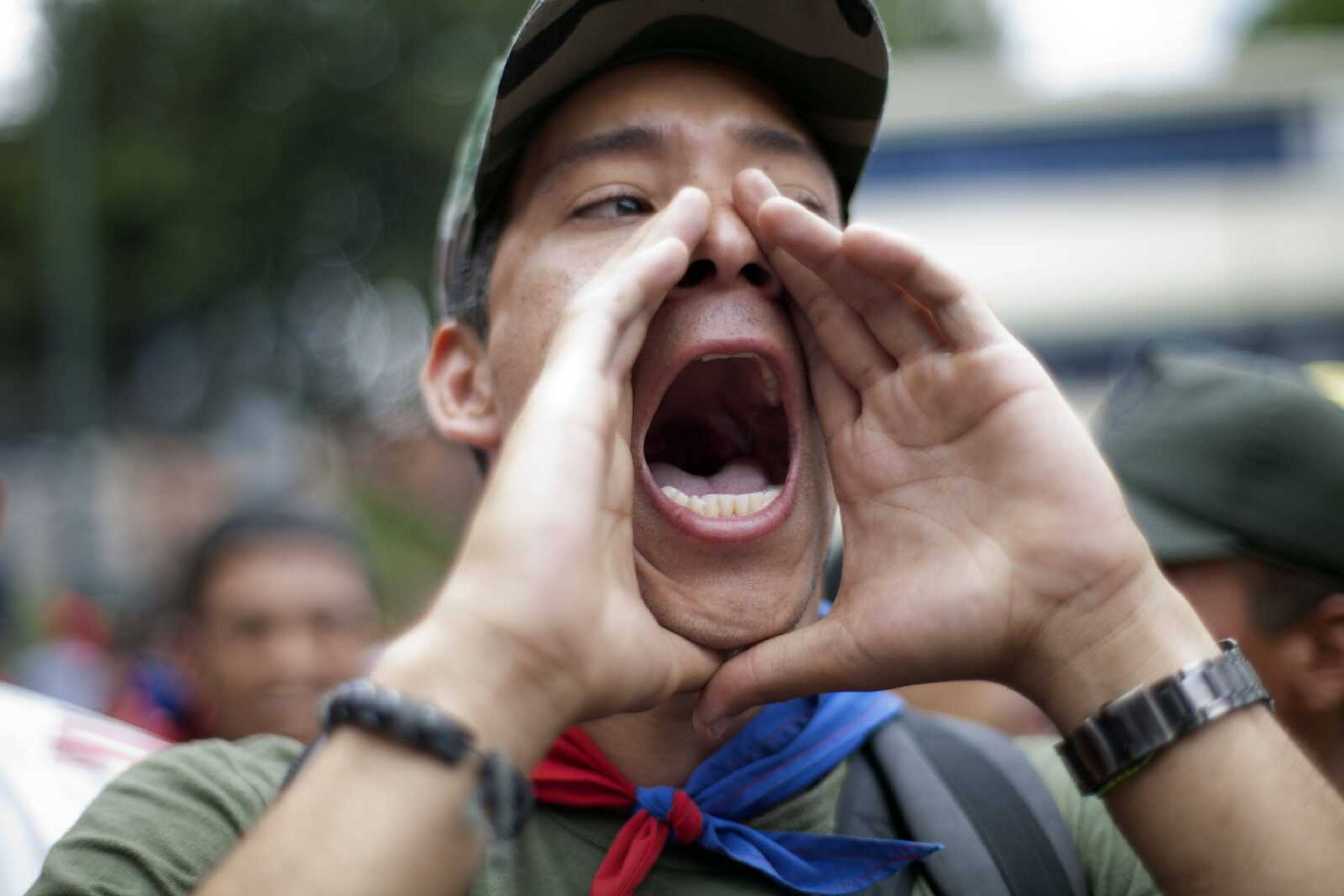 A "Chavista" demonstrator shouts as supporters of President-elect Nicolas Maduro march in front of the National Electoral Council (CNE) in Caracas,Venezuela, Wednesday, April 17, 2013. Opposition candidate Henrique Capriles has presented a series of allegations of vote fraud and other irregularities to back up his demand for a vote-by-vote recount for the presidential election. (AP Photo/Ramon Espinosa)