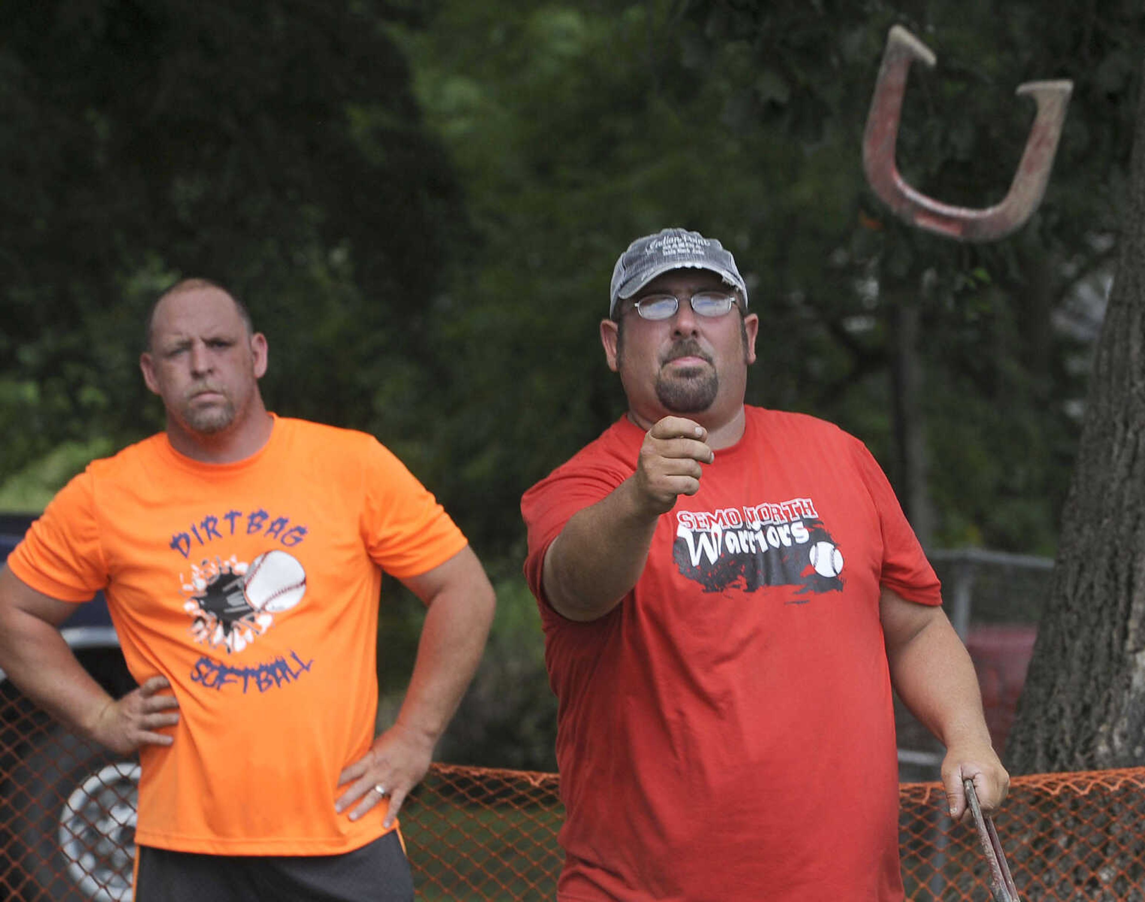 FRED LYNCH ~ flynch@semissourian.com
Daniel Rains pitches a horseshoe as Dean Foulk watches during a tournament at the Chaffee German Days on Saturday, Aug. 9, 2014 at Frisco Park in Chaffee, Missouri.