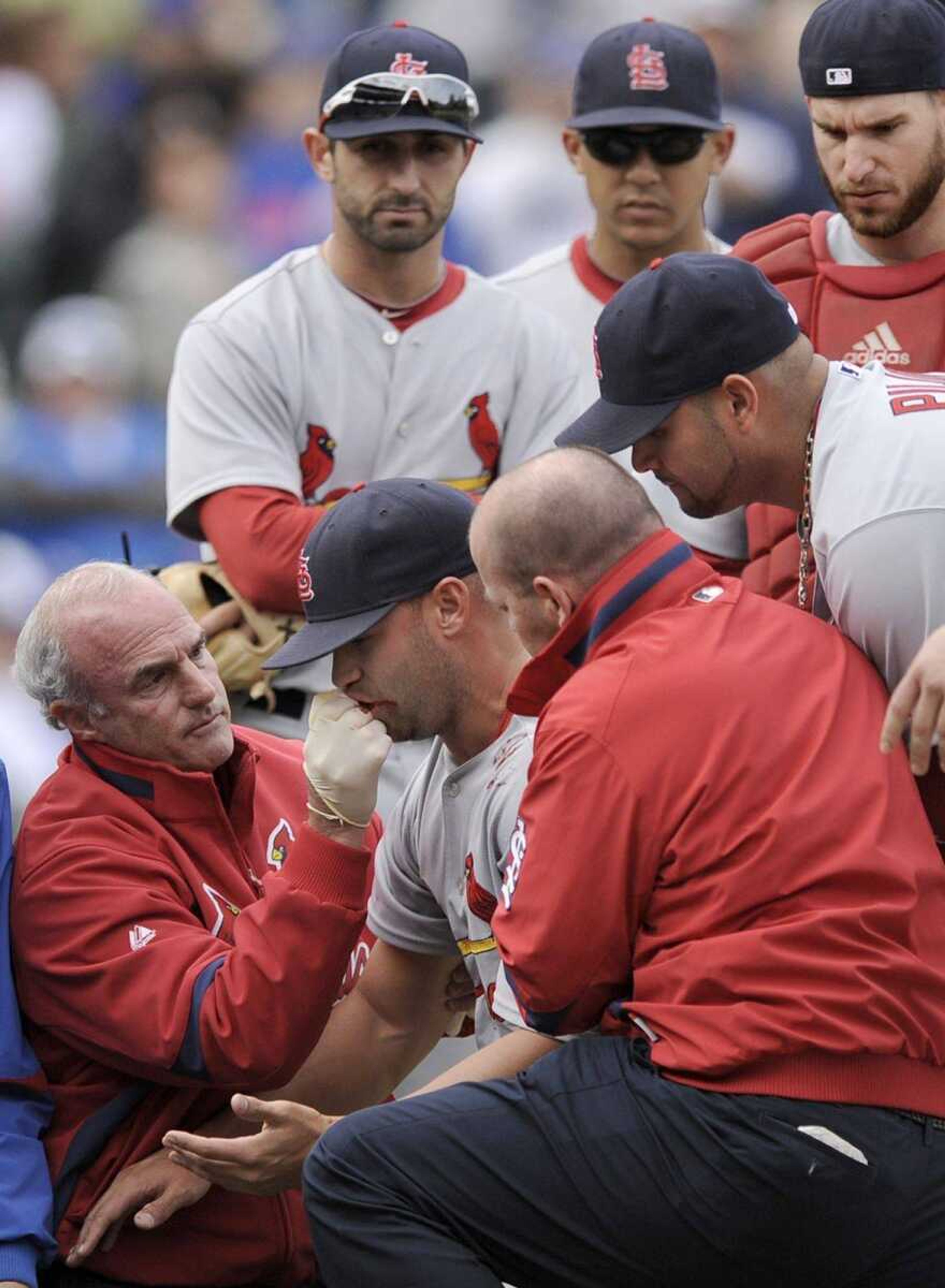 Cardinals pitcher Blake Hawksworth has his mouth tended to after being hit by a line drive during Saturday's game against the Cubs in Chicago. (PAUL BEATY ~ Associated Press)