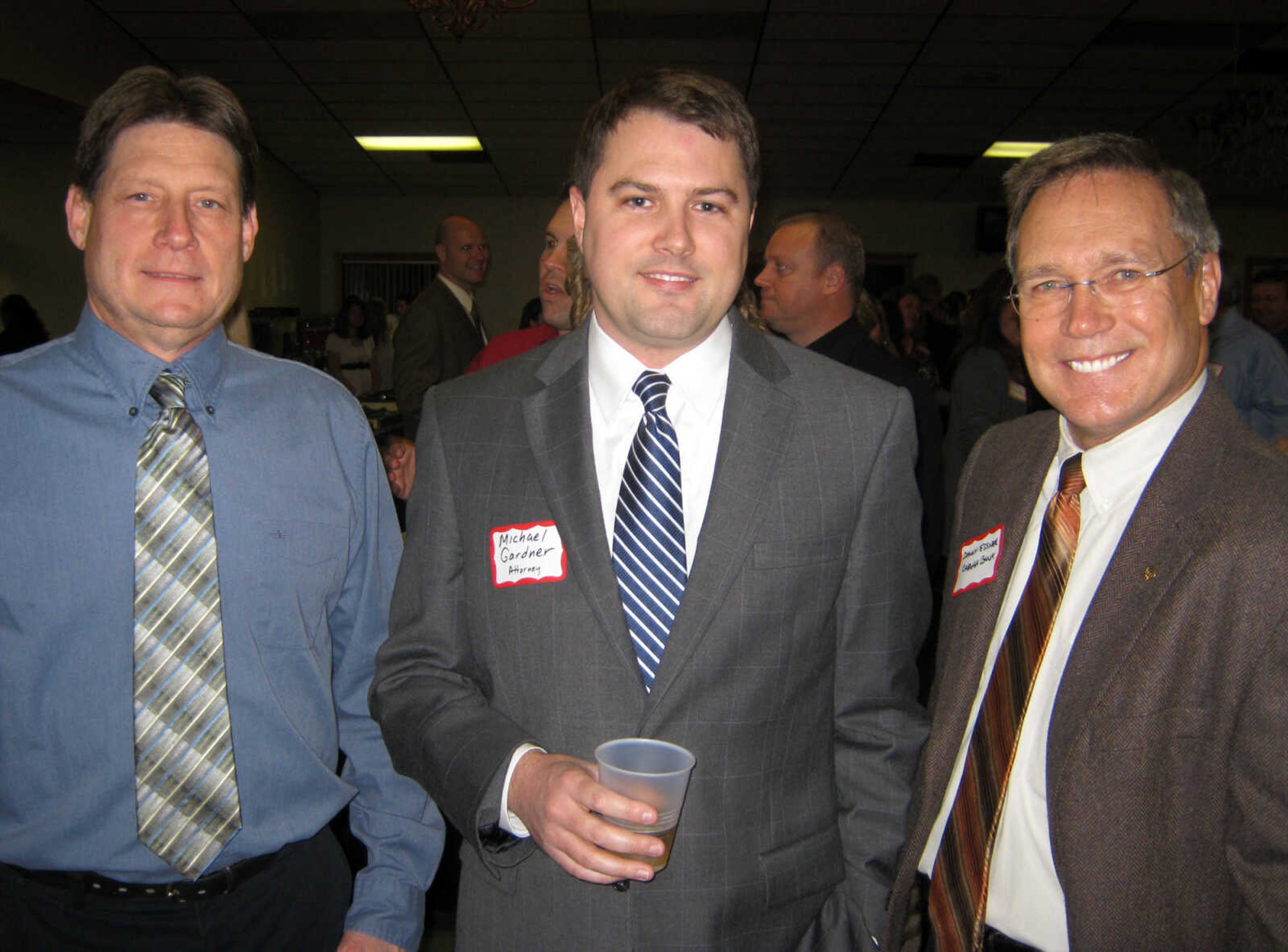 Roger Seyer, S&W Cabinets, left; Michael Gardner, attorney; and Danny Essner, Capaha Bank pose at the Jackson Area Chamber of Commerce annual awards banquet, Jan. 11, at the the Knights of Columbus Hall in Jackson, Mo.