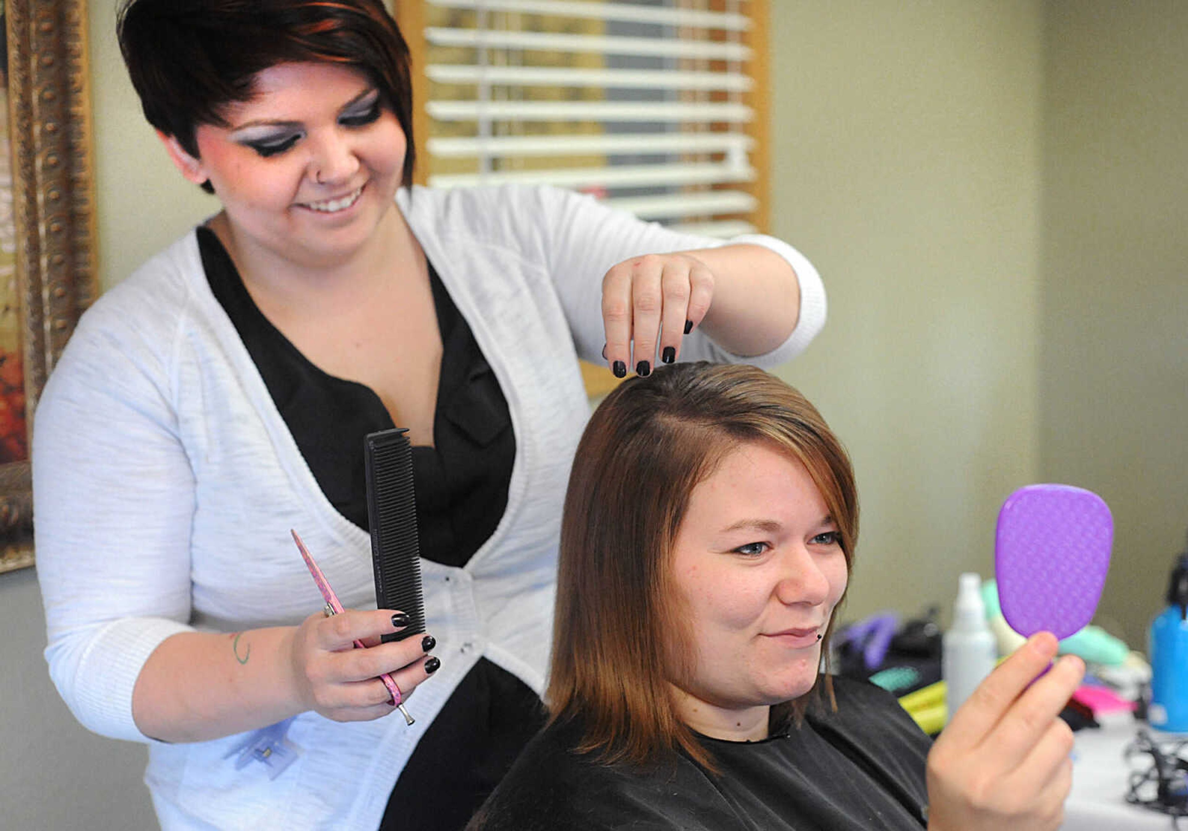 LAURA SIMON ~ lsimon@semissourian.com

Halei checks on the progress of her haircut from Kaylee Bowen from Belladona Salon and Spa, Wednesday, Oct. 29, 2014, during the members of Gibson Recovery Center Inc.'s Vision House program beauty day. Consultants from Belladona Salon and Spa, Mary Kay, and Eye Candy gave the members a fresh look with an eyebrow threading, haircut and makeup session.