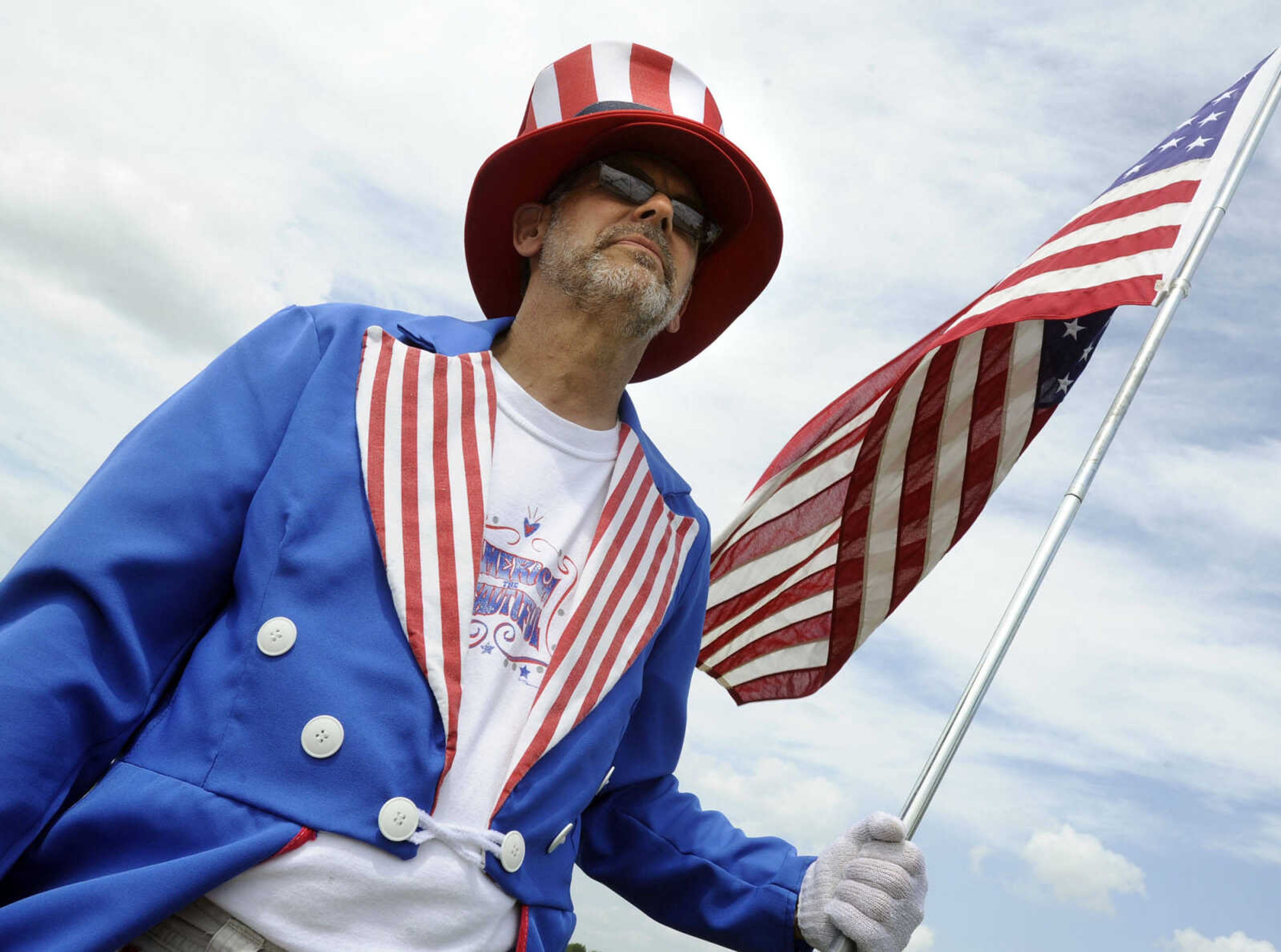 Dressed as Uncle Sam, Lee Unterreiner of Perryville, Mo. waits for the arrival of The Wall That Heals on Tuesday, June 17, 2014 in Perryville, Mo.