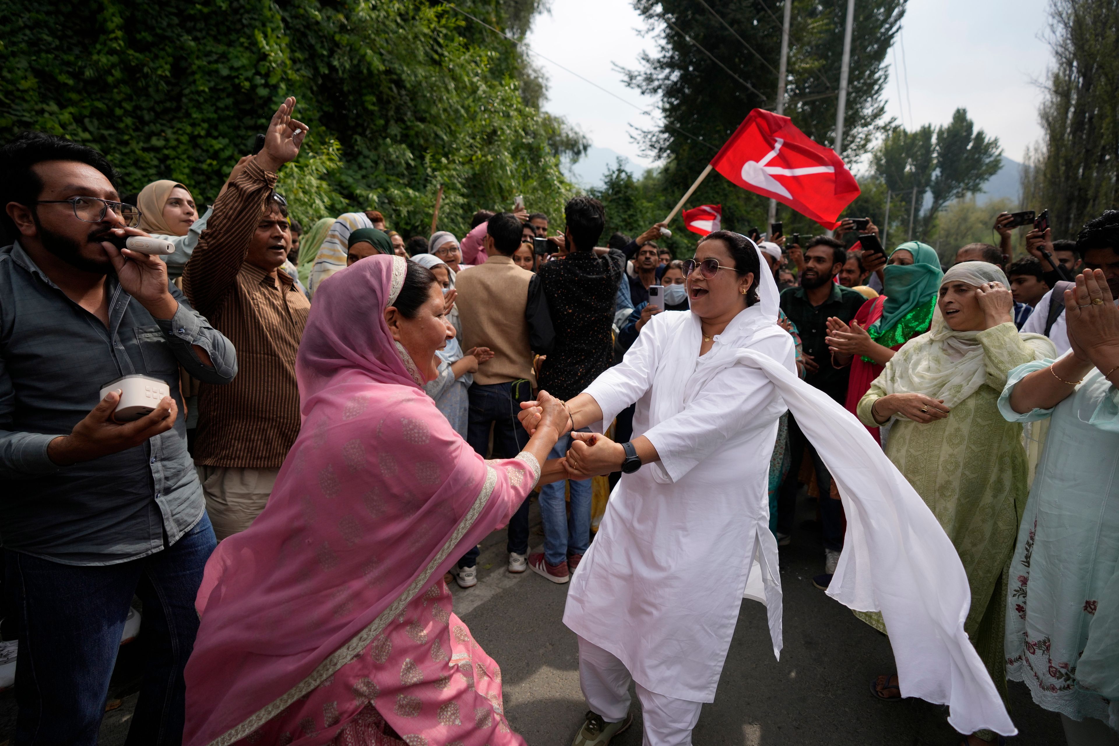 Supporters of Indian National Congress and National Conference party celebrate early leads in election outside a counting center on the outskirts of Srinagar, Indian controlled Kashmir, Tuesday, Oct. 8, 2024. (AP Photo/Mukhtar Khan)